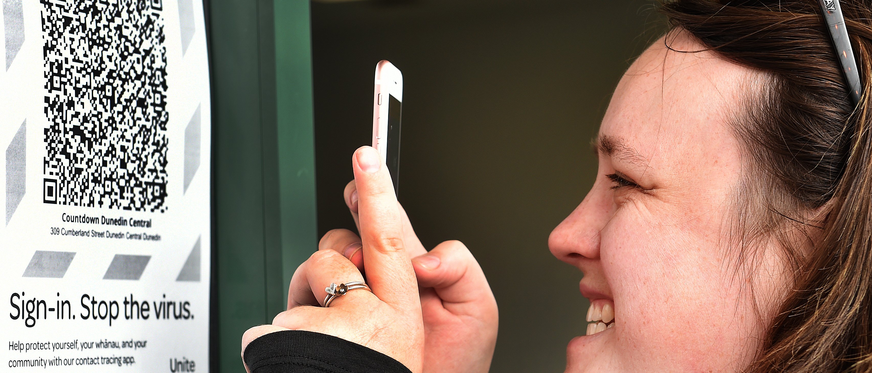 Chanelle Carter, of Waimumu, uses her Covid Tracer app in Dunedin yesterday. PHOTO: PETER MCINTOSH
