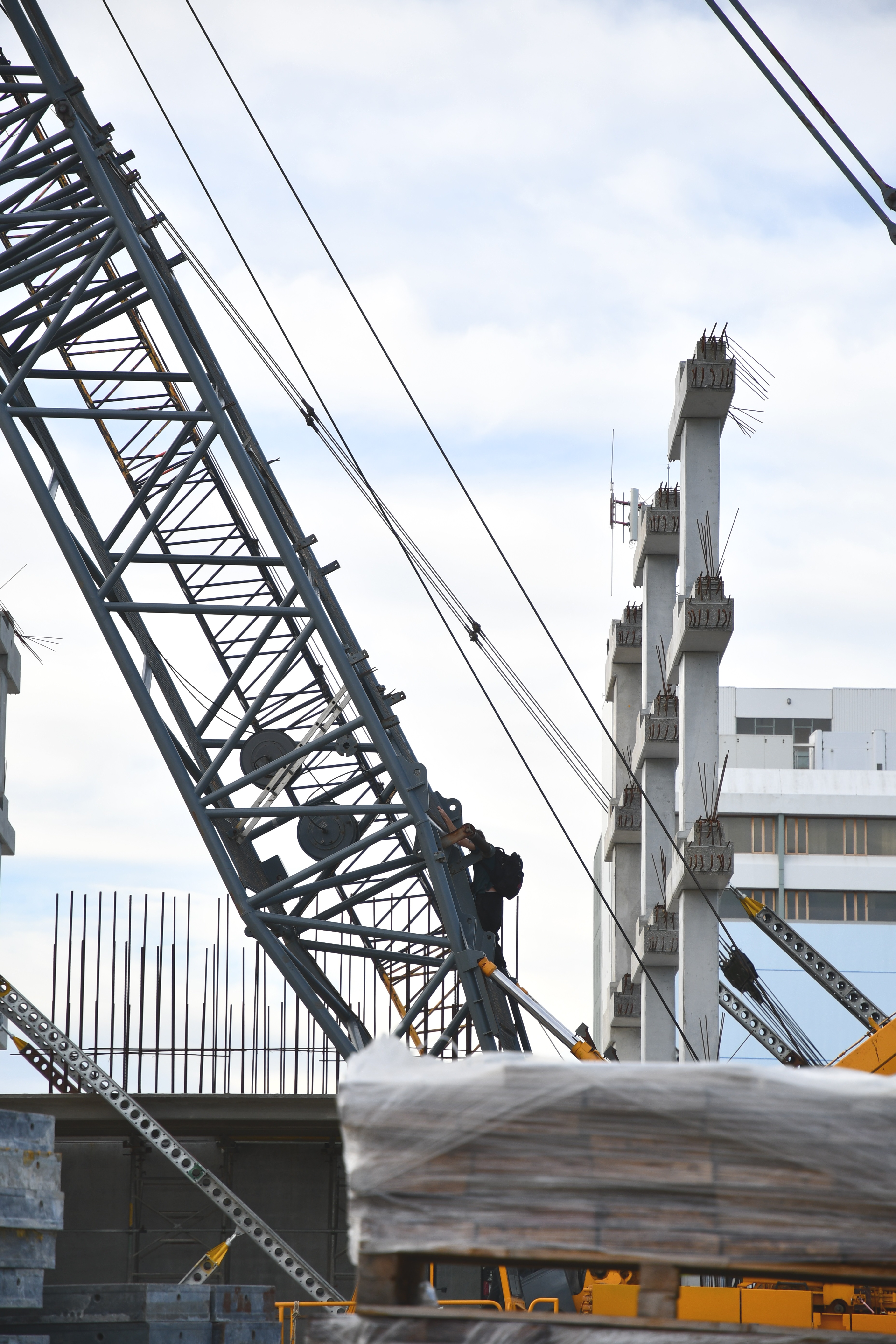 A man scales a crane in the Invercargill CBD. Photo: Laura Smith