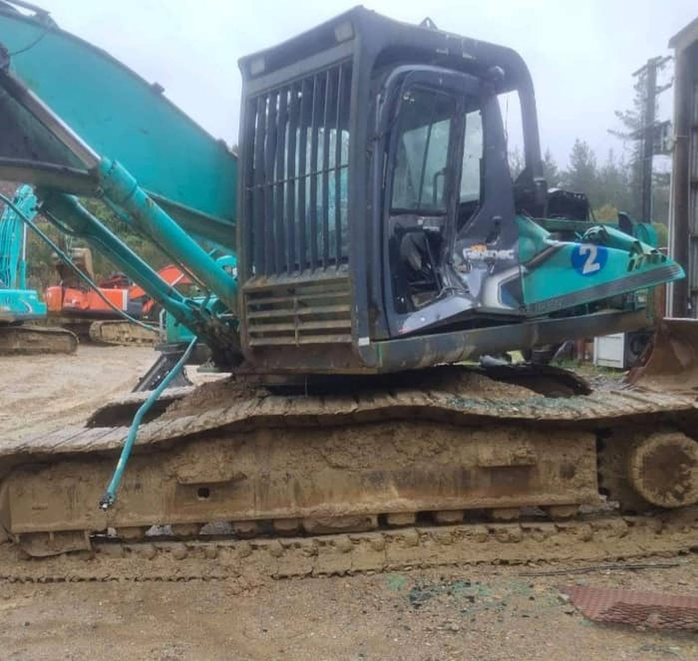 A digger had its door and panels smashed in during the rampage. Photo: Supplied