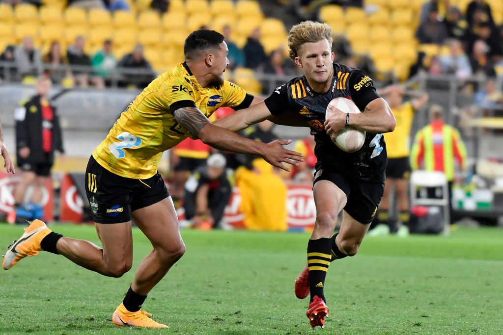The Chiefs' Damian McKenzie tries to get past Billy Proctor of the Hurricanes. Photo: Getty 