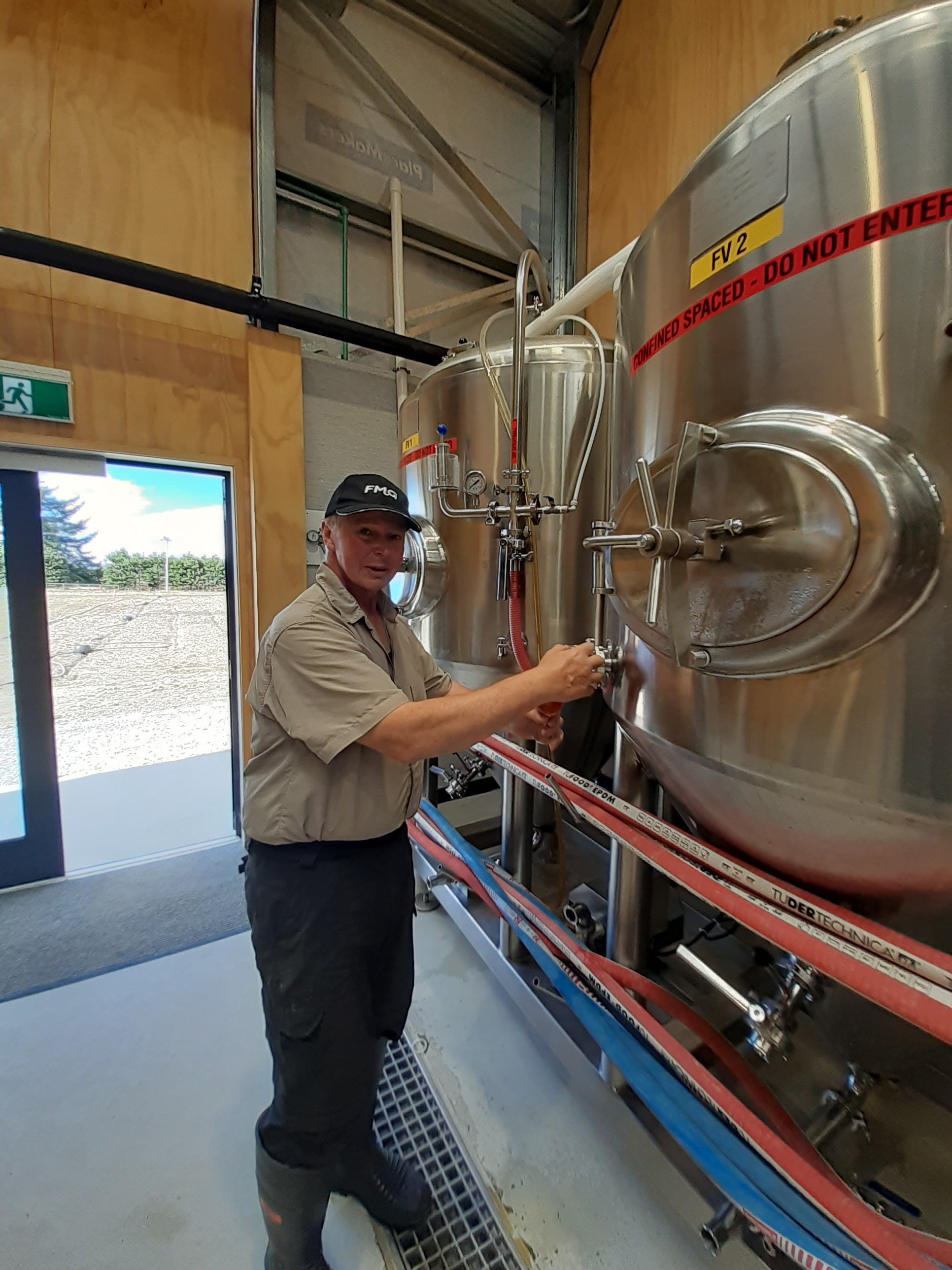 Grenville Caughey checks the product at the Otago Polytechnic Brew School’s commercial brewery.