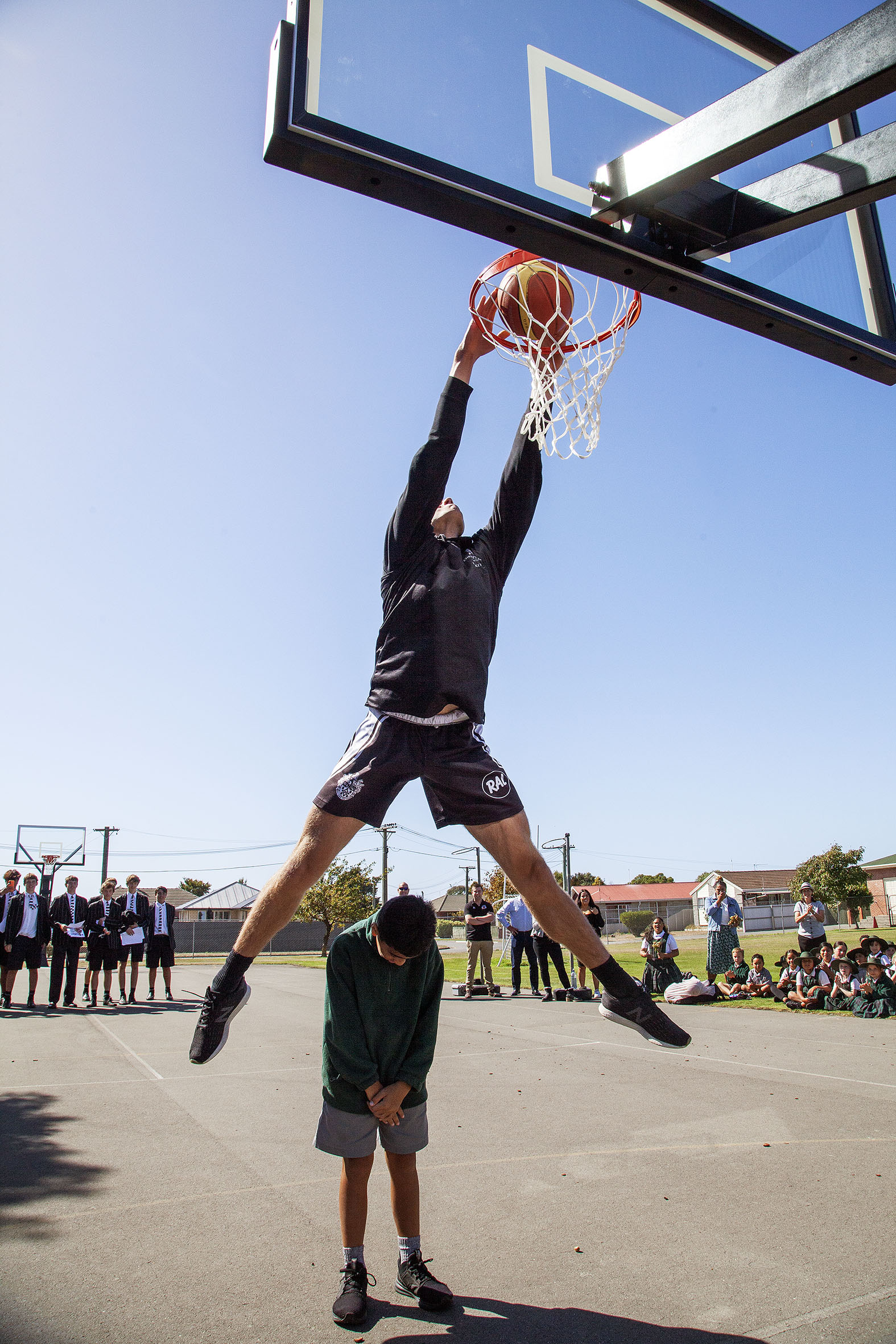 Christ's College basketball player Hunter Adam jumps over St James pupil Fetu Fenika. Photo:...