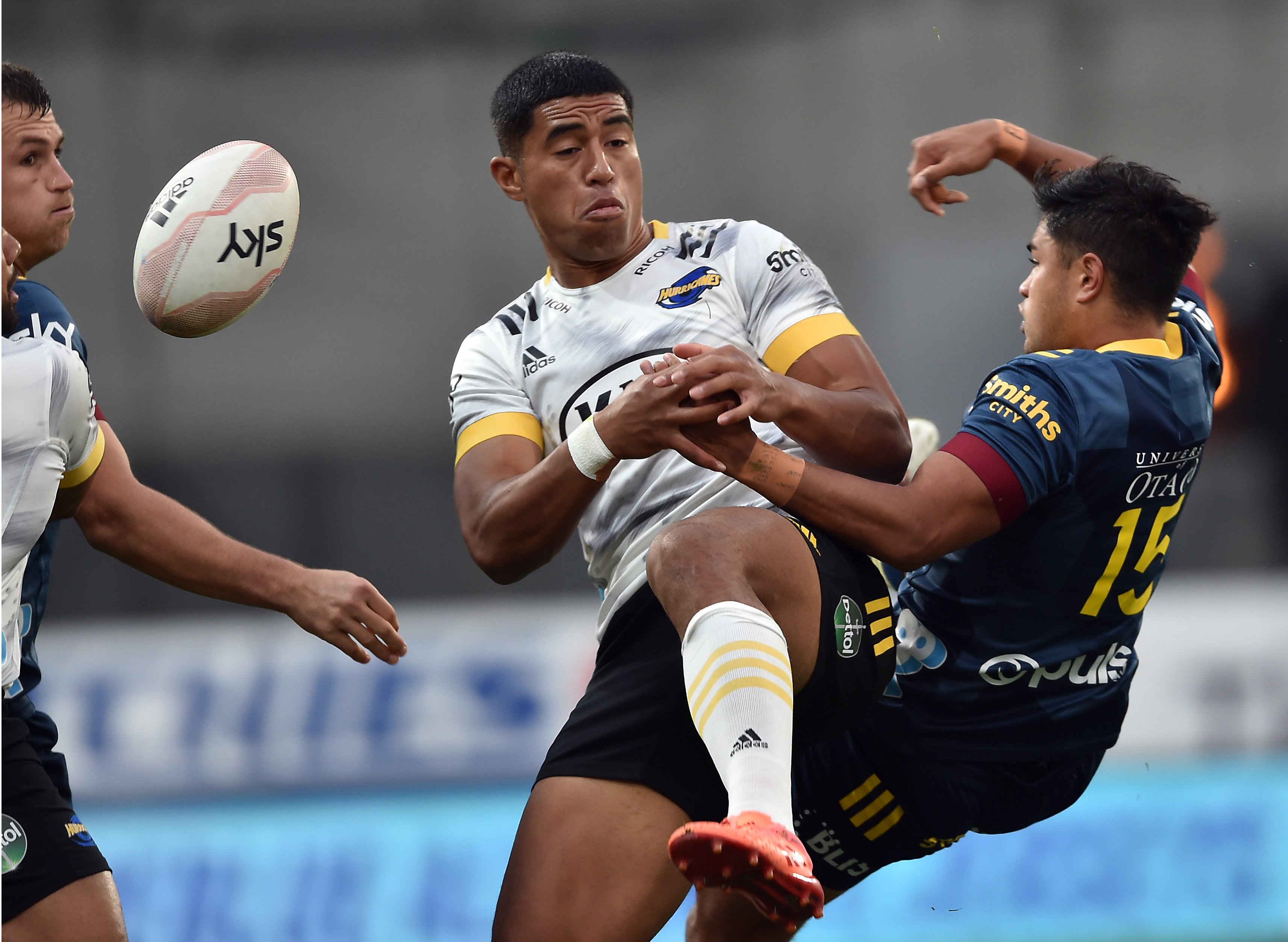 Highlanders centre Michael Collins, Hurricanes winger Salesi Rayasi and Highlanders fullback Josh...