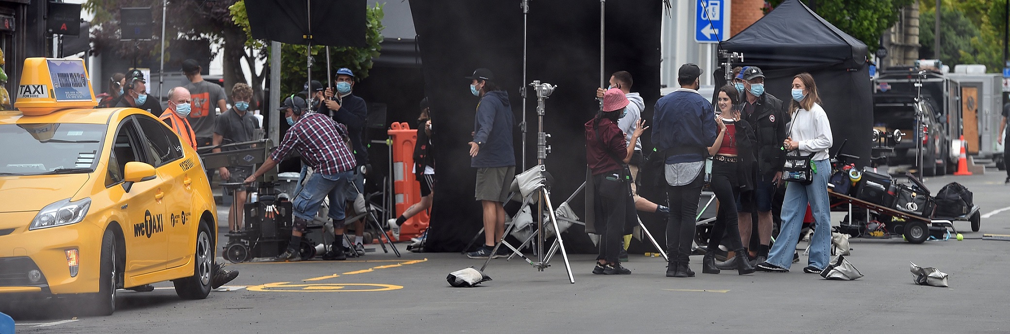 American actress and singer Laura Marano (third from right) takes a break between takes on the...