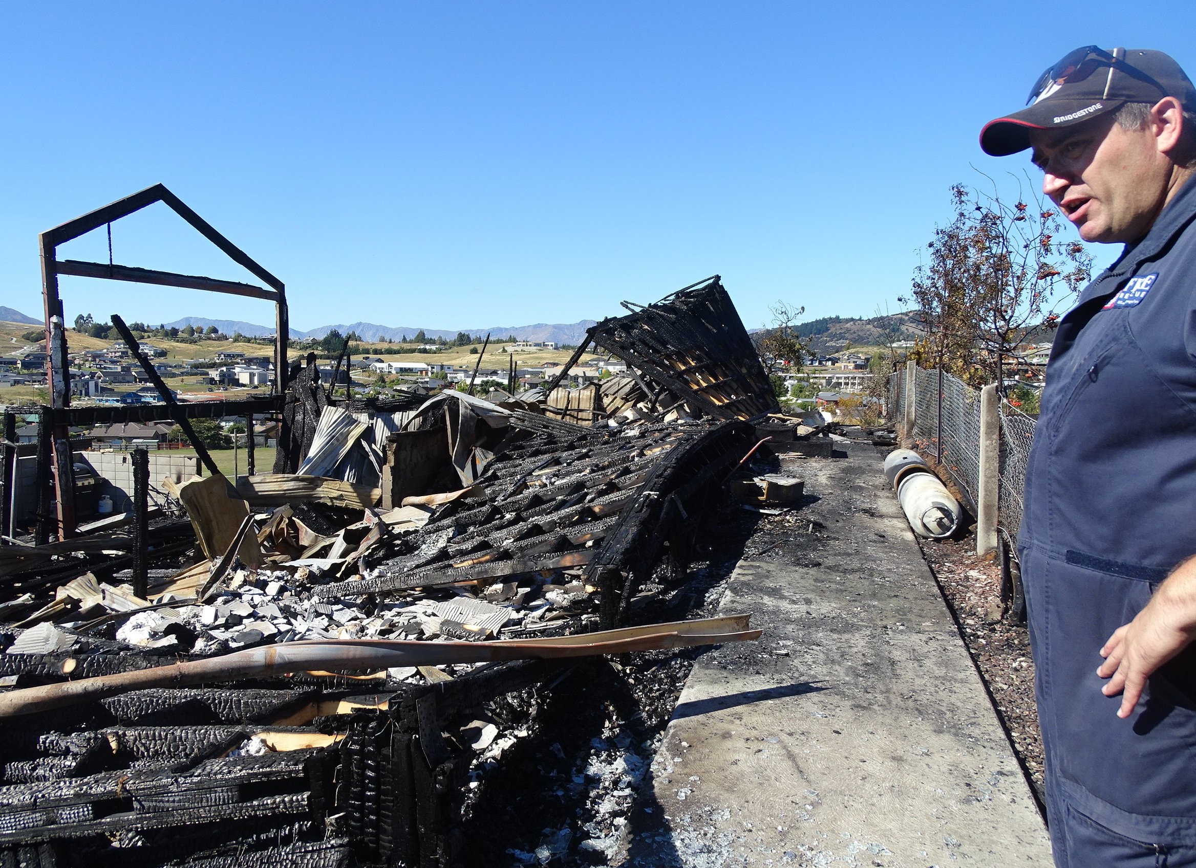 Fire investigator John Smalls examines the destroyed house. Photo: Kerrie Waterworth.