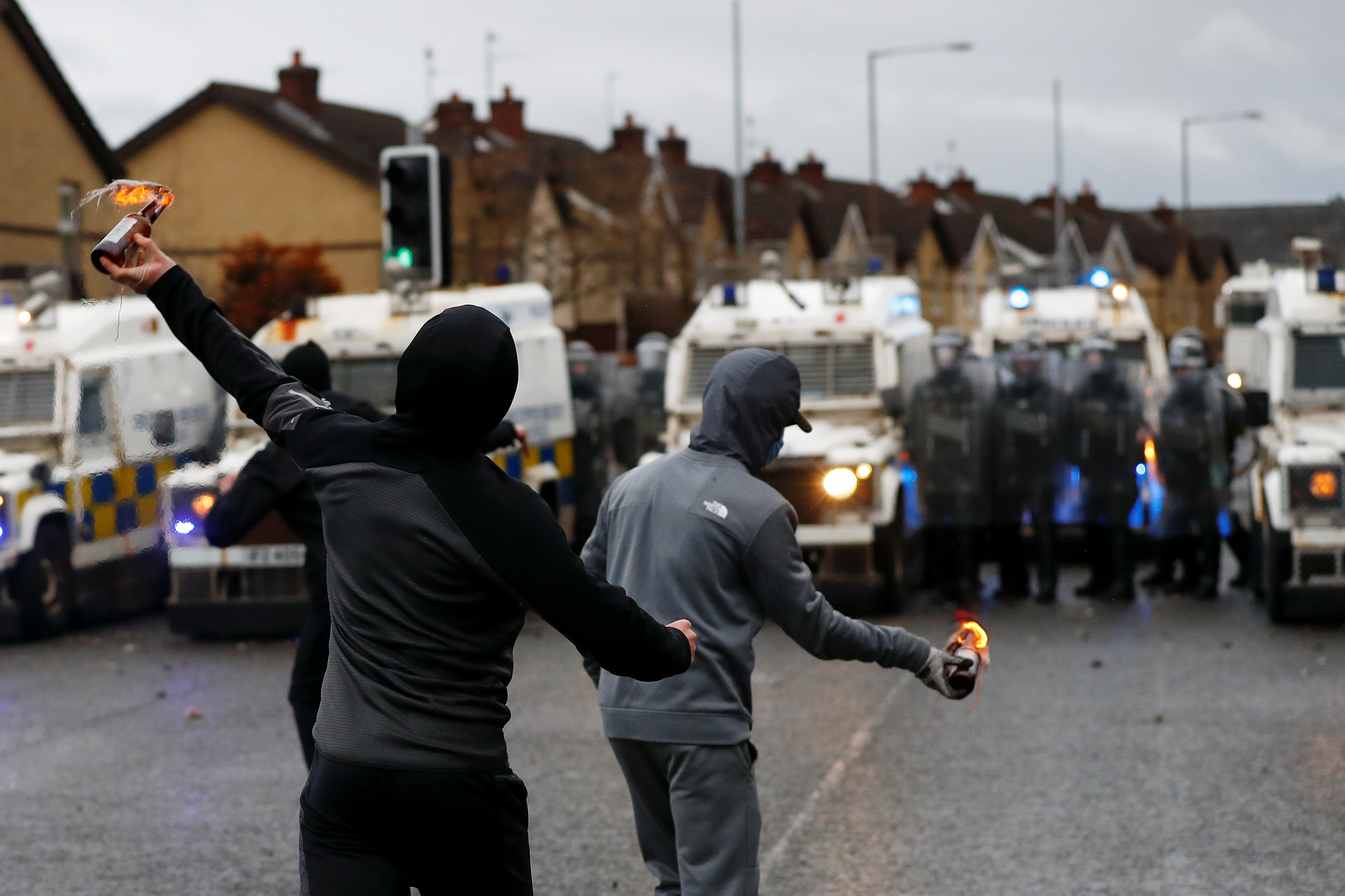 Rioters throw burning bottles at police on the Springfield Rd as protests continued in Belfast on...