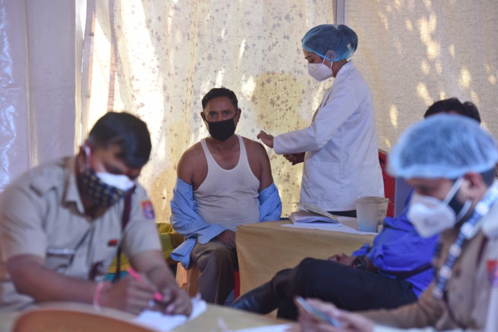 A health worker administers a dose of Covid-19 vaccine, at ESIC (Indira Gandhi) Hospital Jhilmil...