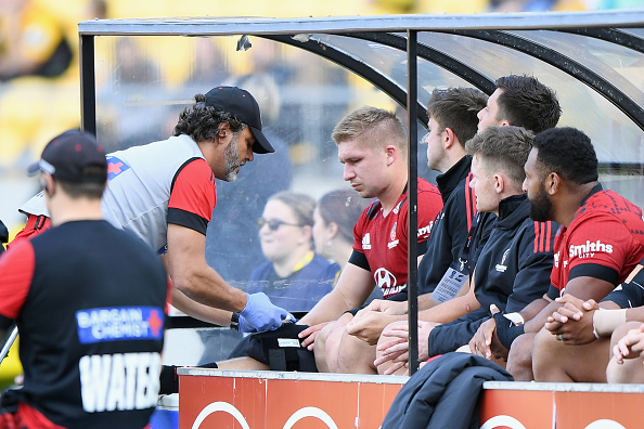 Jack Goodhue receives medical help during the match against the Hurricanes. Photo: Getty Images