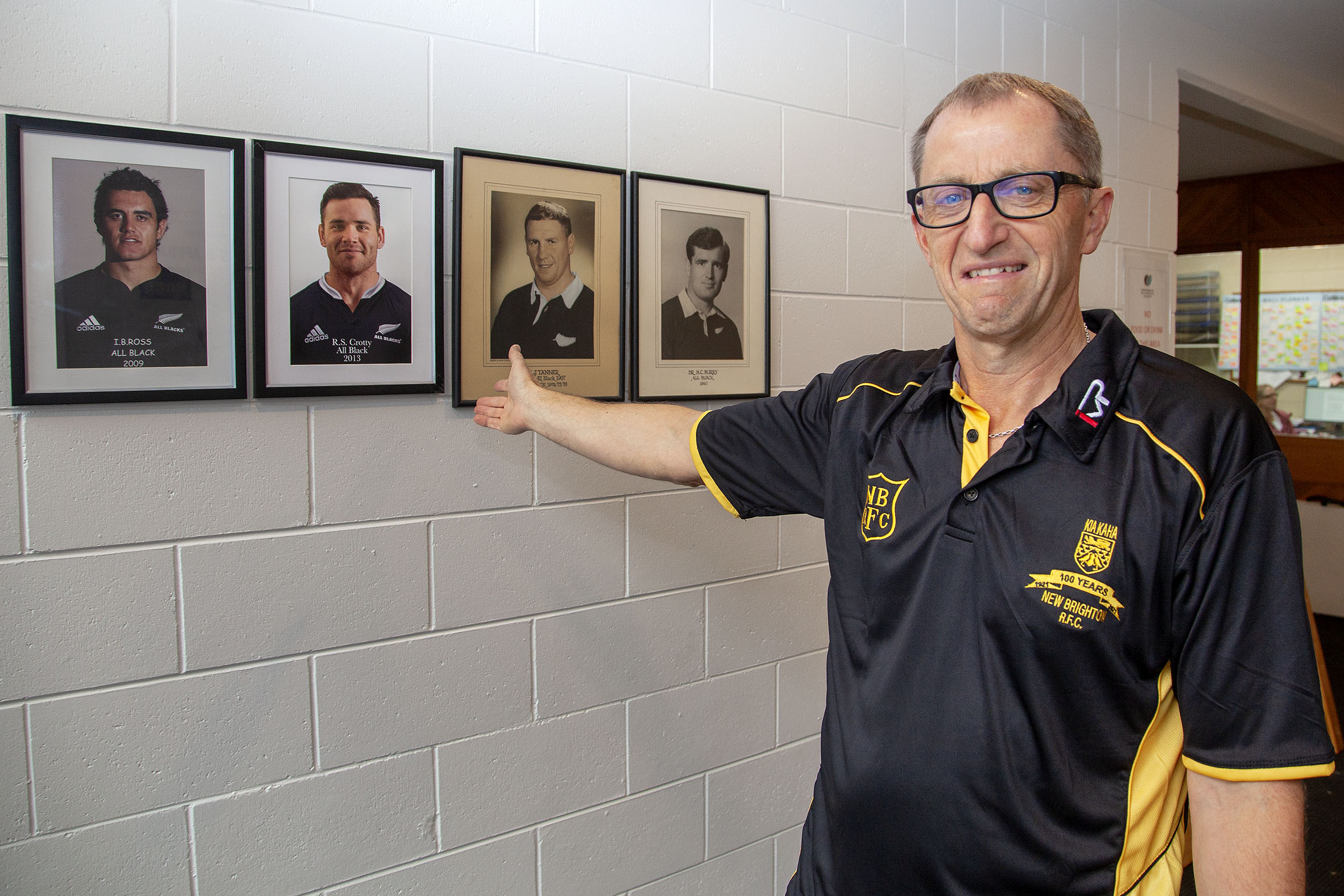 New Brighton Rugby Club centenary committee chairman Wayne Turner with photos of the club’s four...