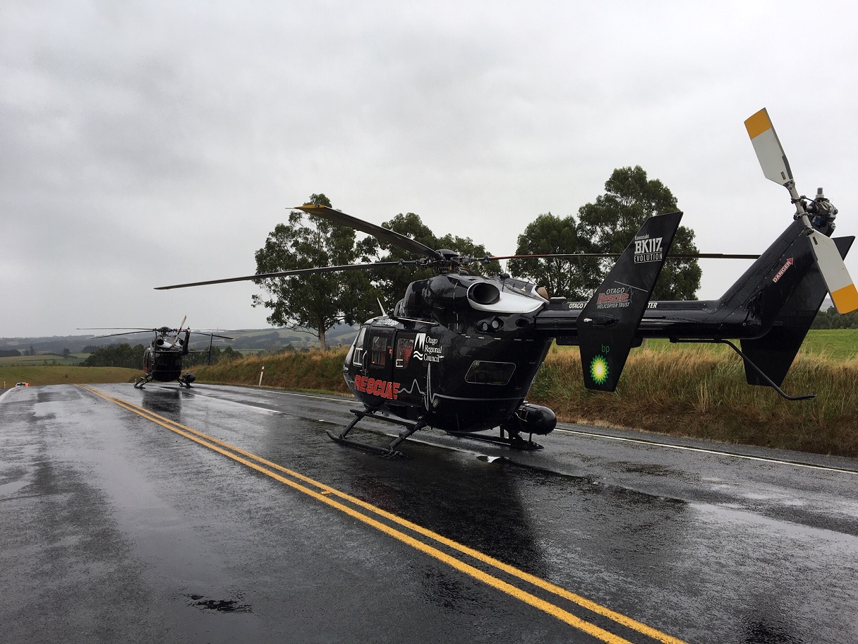 Rescue helicopters on the highway near the crash site. Photo: Richard Davison