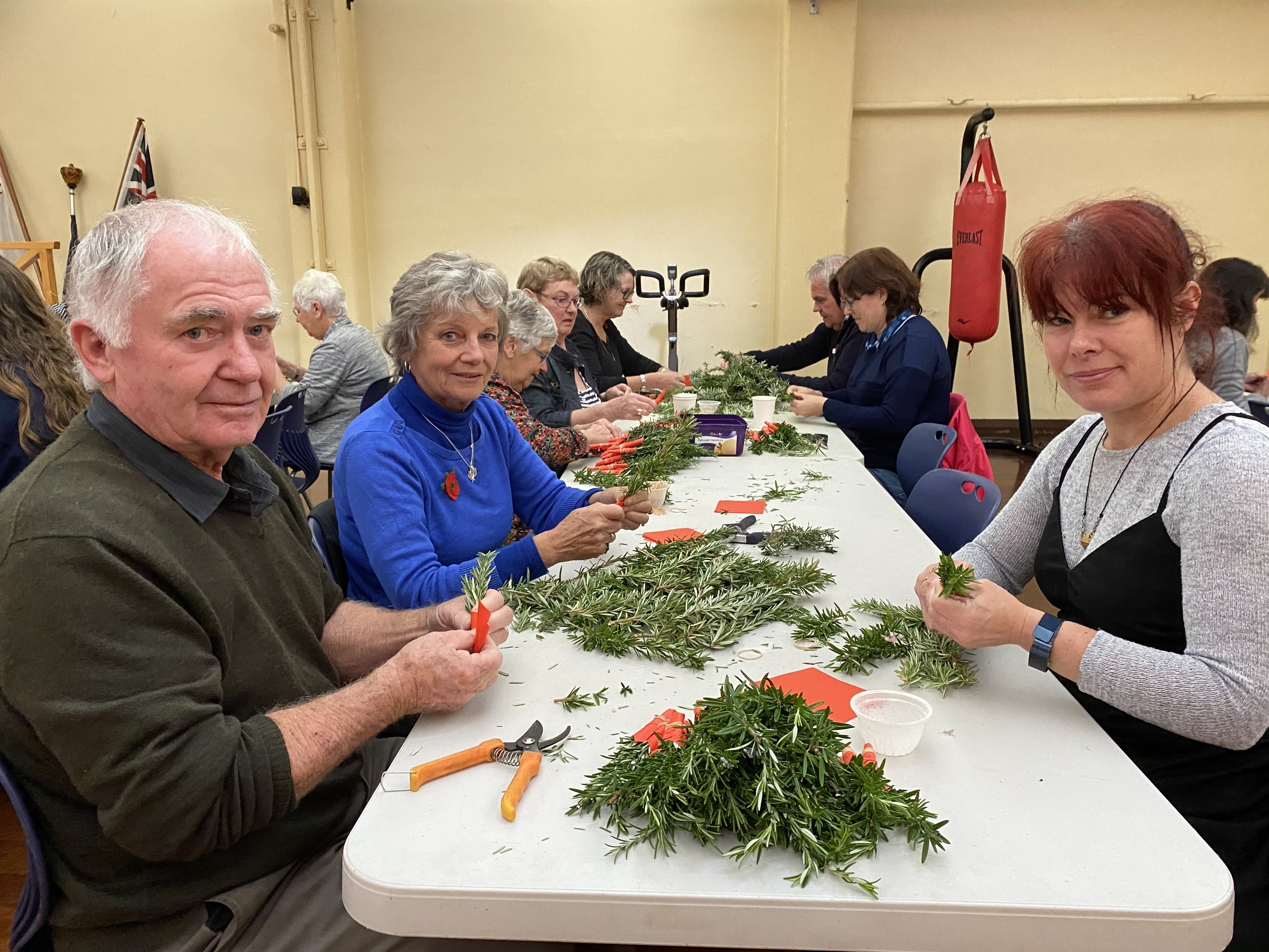 Joining volunteers at HMNZS Toroa in making about 4000 rosemary posies for Anzac Day were (from...