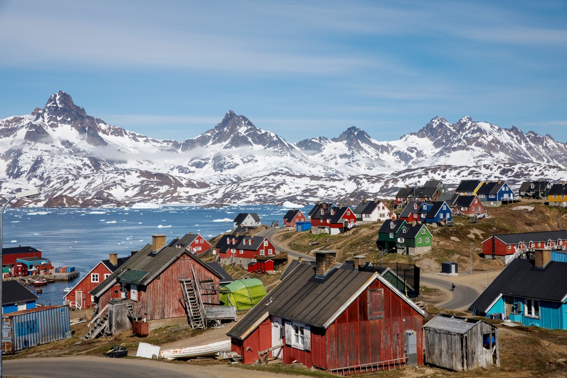 Mountains rise above the harbour and town of Tasiilaq in Greenland. Photo: Reuters