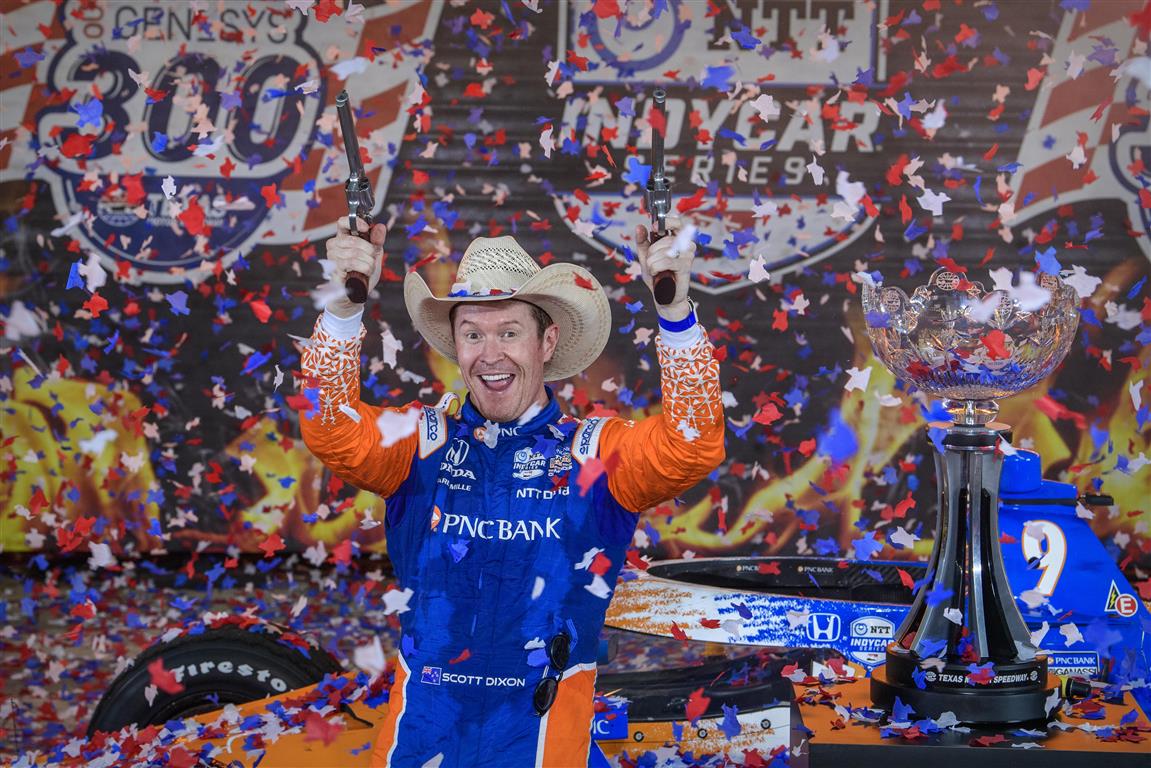 Scott Dixon fires off six shooters as he celebrates his victory in the Genesys 300 race at Texas...