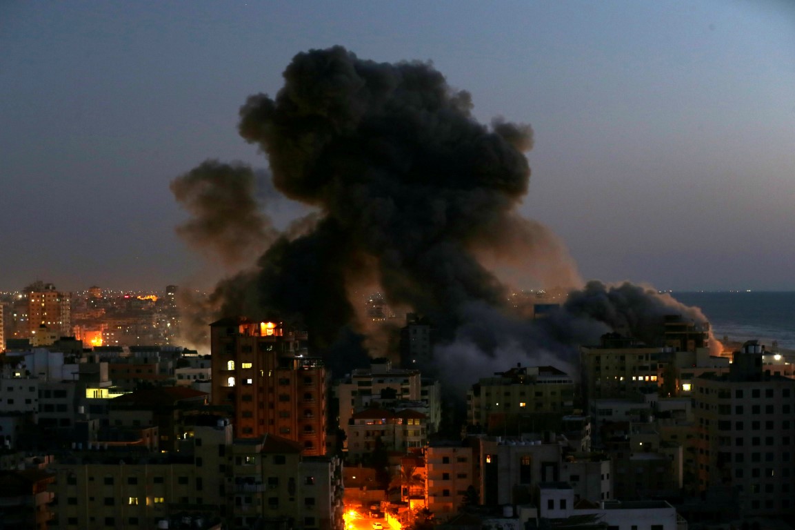 Smoke rises from a building in Gaza after it was destroyed by Israeli air strikes amid a flare-up...