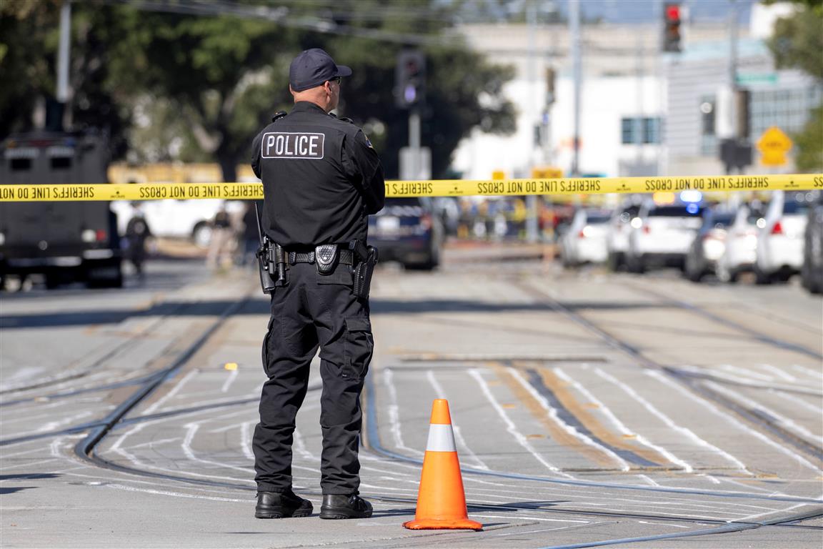 Police secure the scene following the shooting at a rail yard run by the Santa Clara Valley...