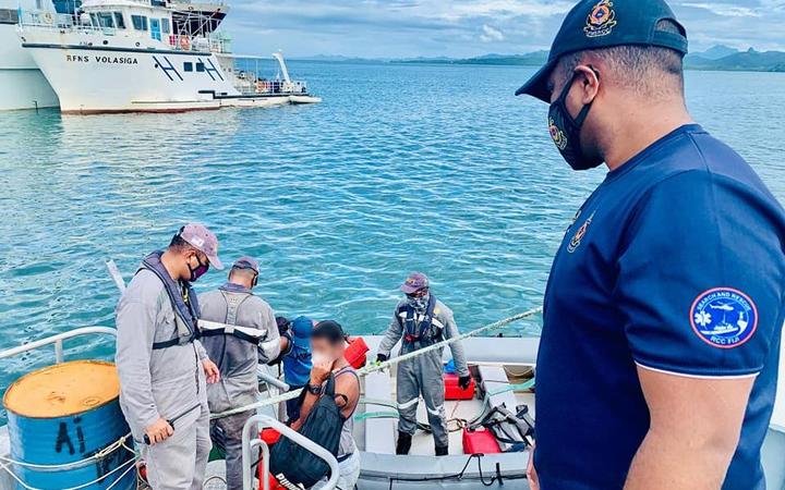 A Fijian Navy crew hand over to Fiji police the survivors found on board the FV TIRO II. Photo:...