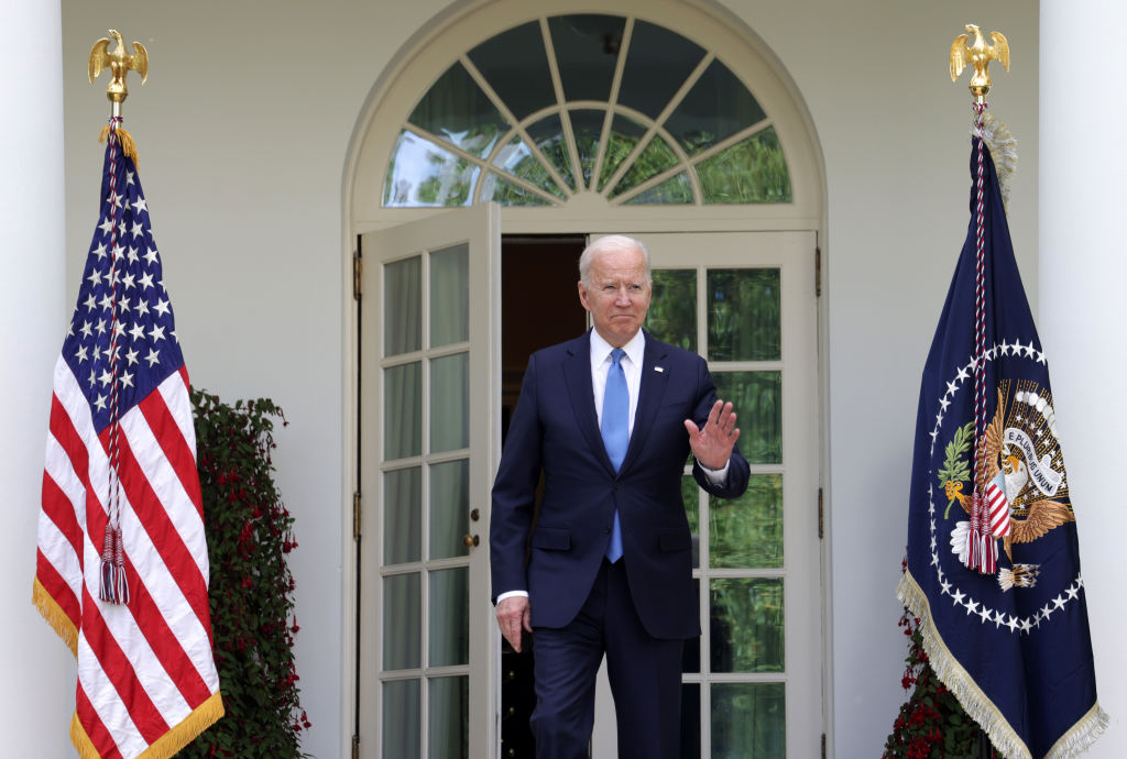 US President Joe Biden arrives without a mask in the Rose Garden at the White House to deliver...