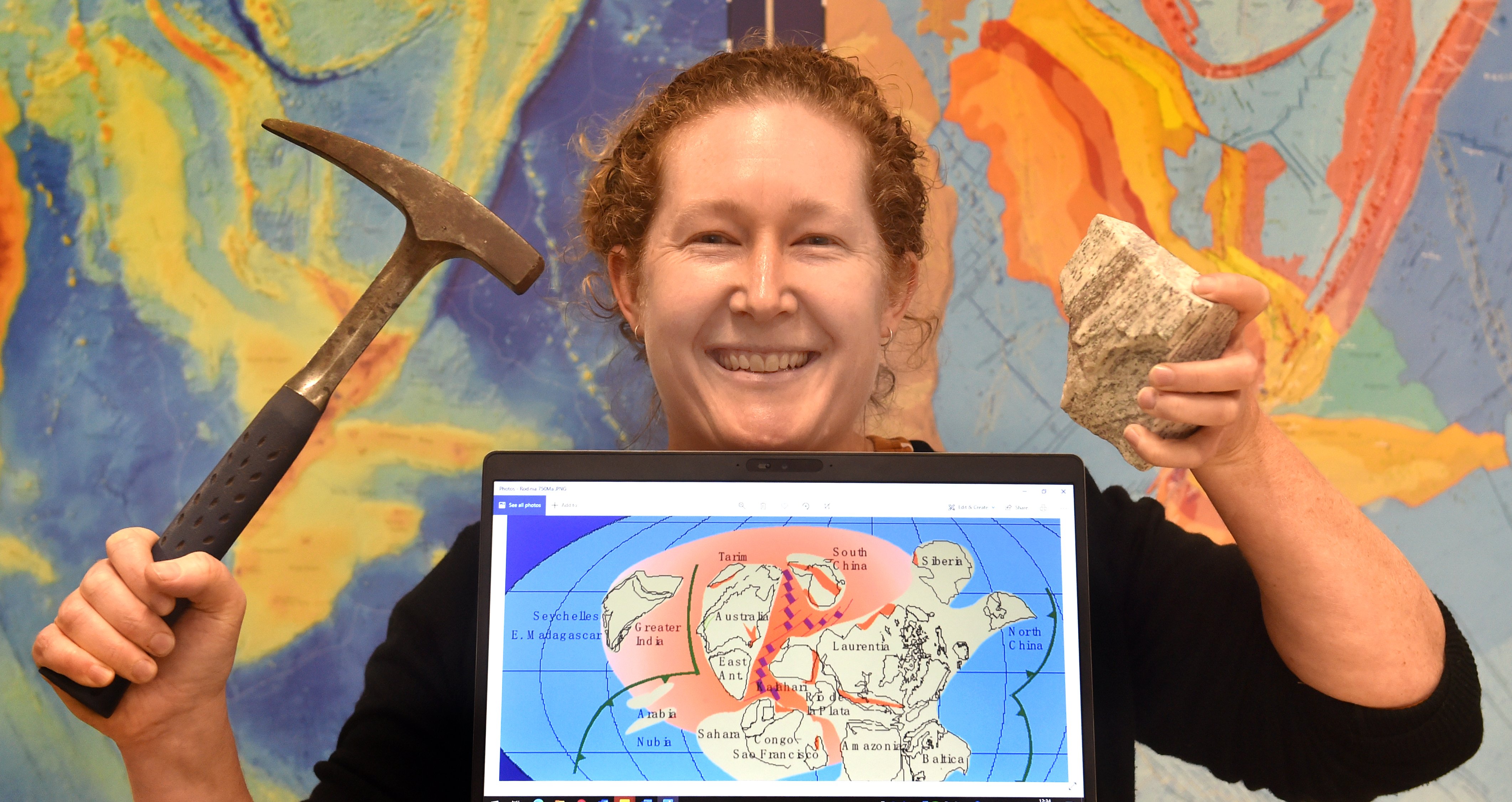 GNS Science geologist Dr Rose Turnbull with a lump of granite from Fiordland, and a graphic...