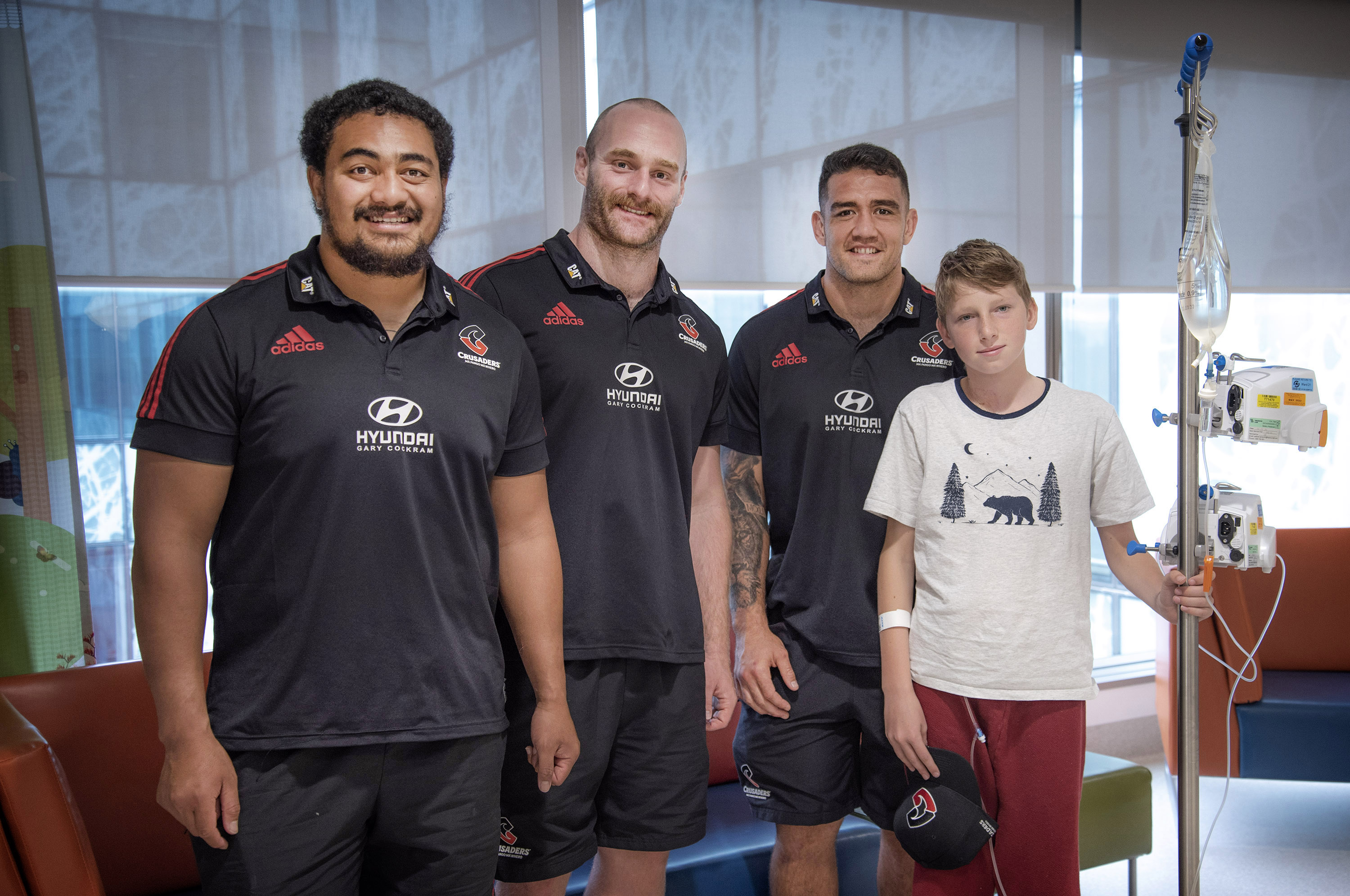 Isi Tu'ungafasi, Oliver Jager and Codie Taylor with a young patient. Photo: Supplied