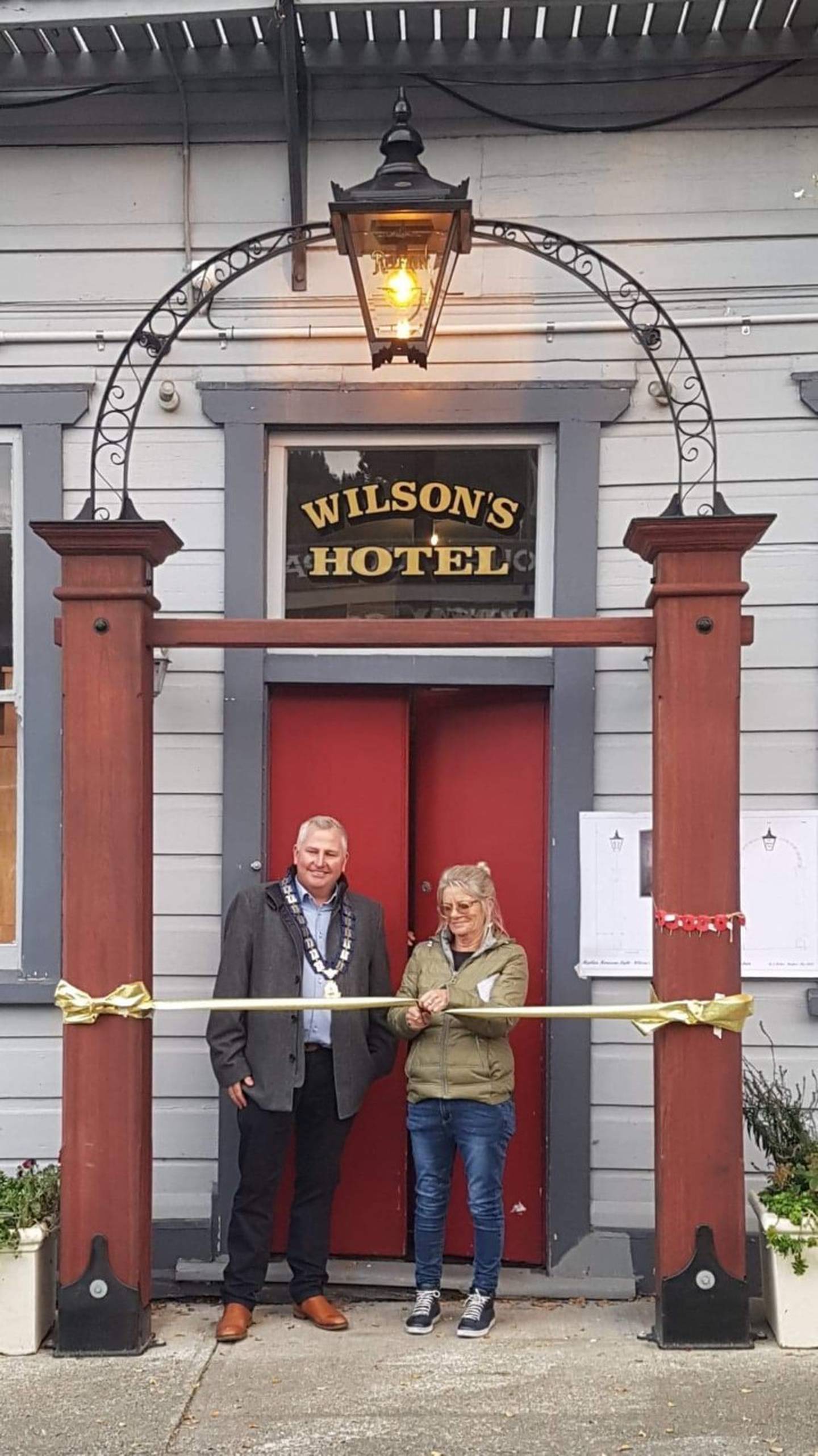Buller Mayor Jamie Cleine and Gwen Gardner at the opening of the pub light. Photo / Supplied