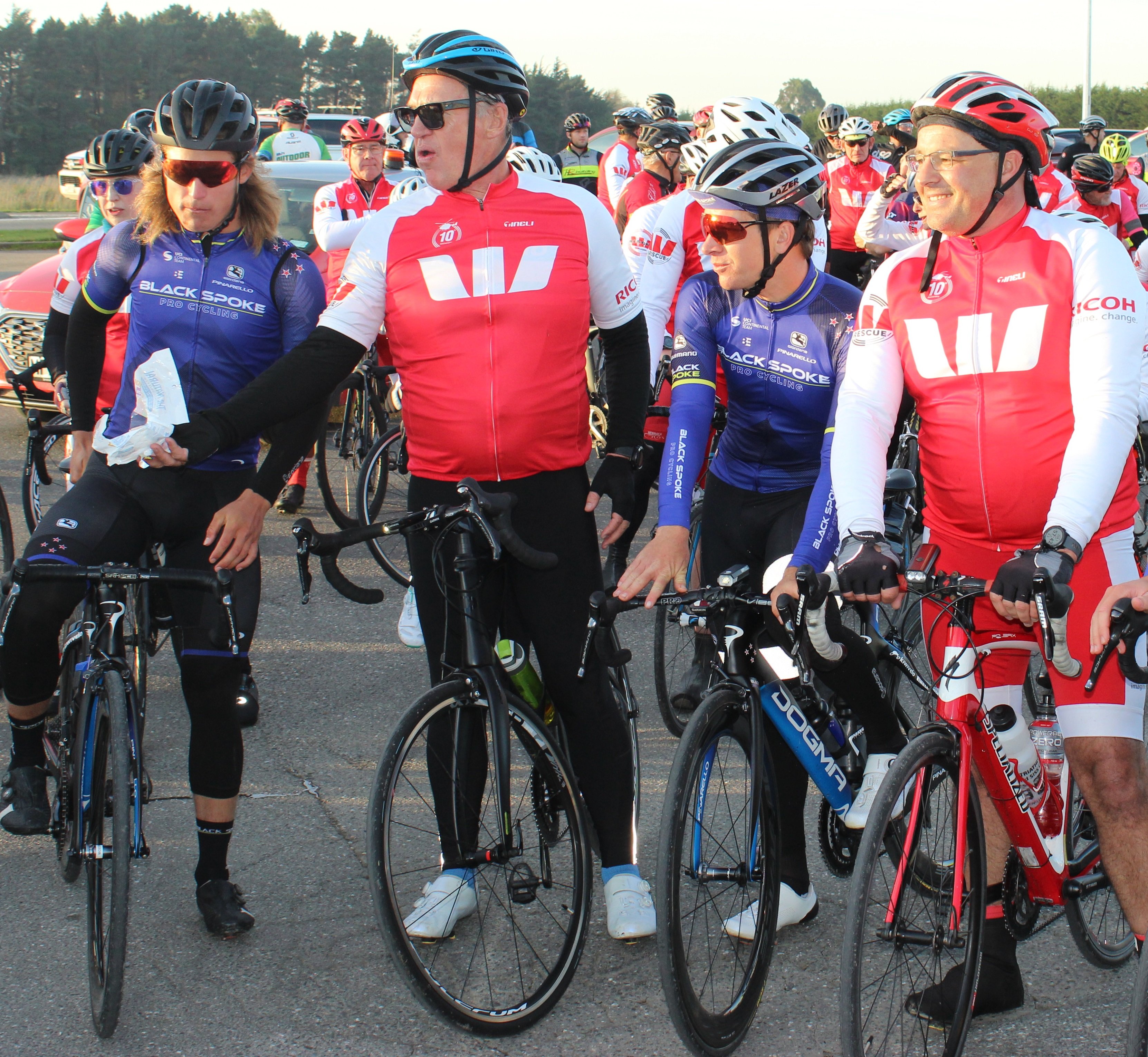 Sir John Kirwan (second from left) hands out the lollies at the second to last stop on the...