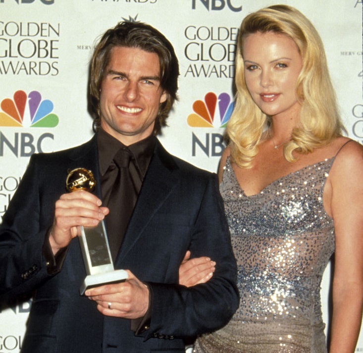 Tom Cruise in 2000 with his Golden Globe for best supporting actor in Magnolia and Charlize...