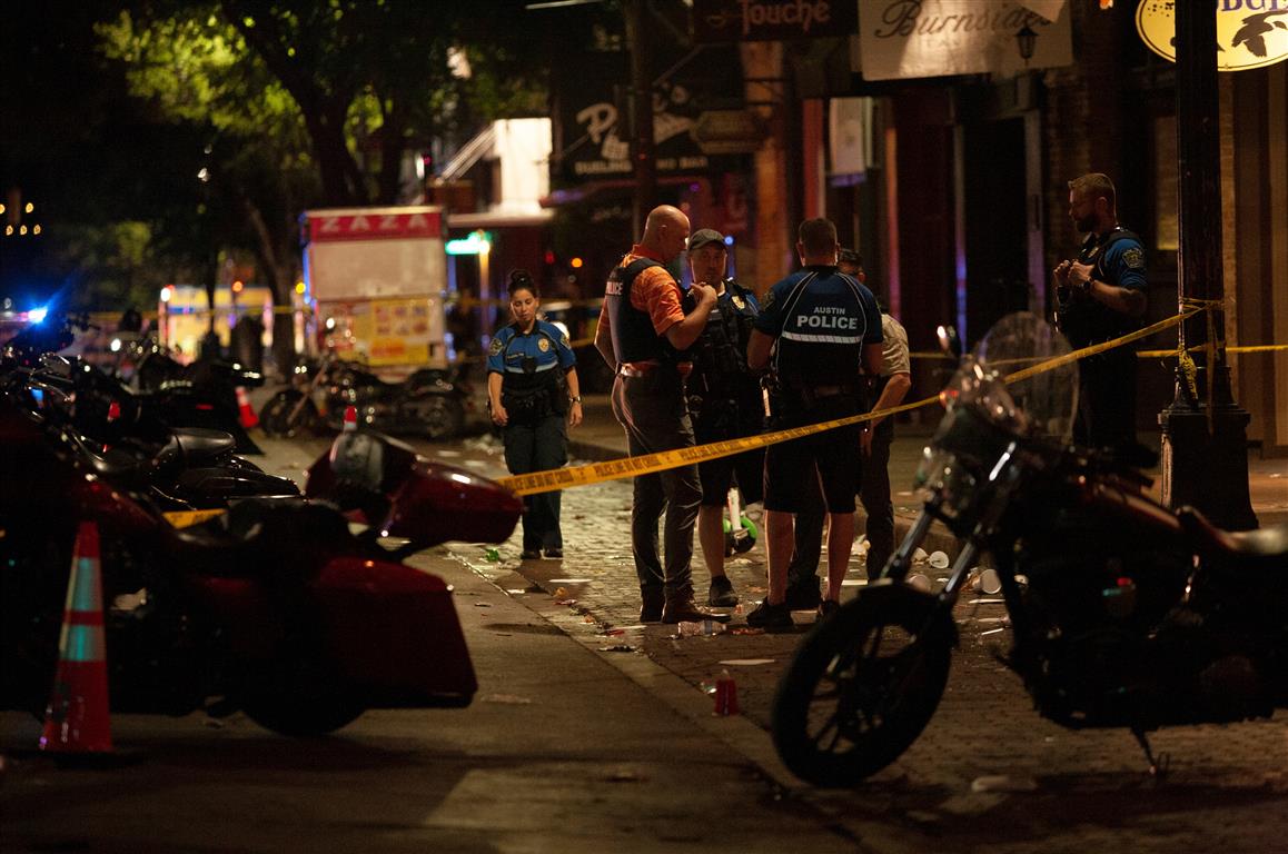 Police at the scene of the shooting in the Sixth Street entertainment district area of Austin....