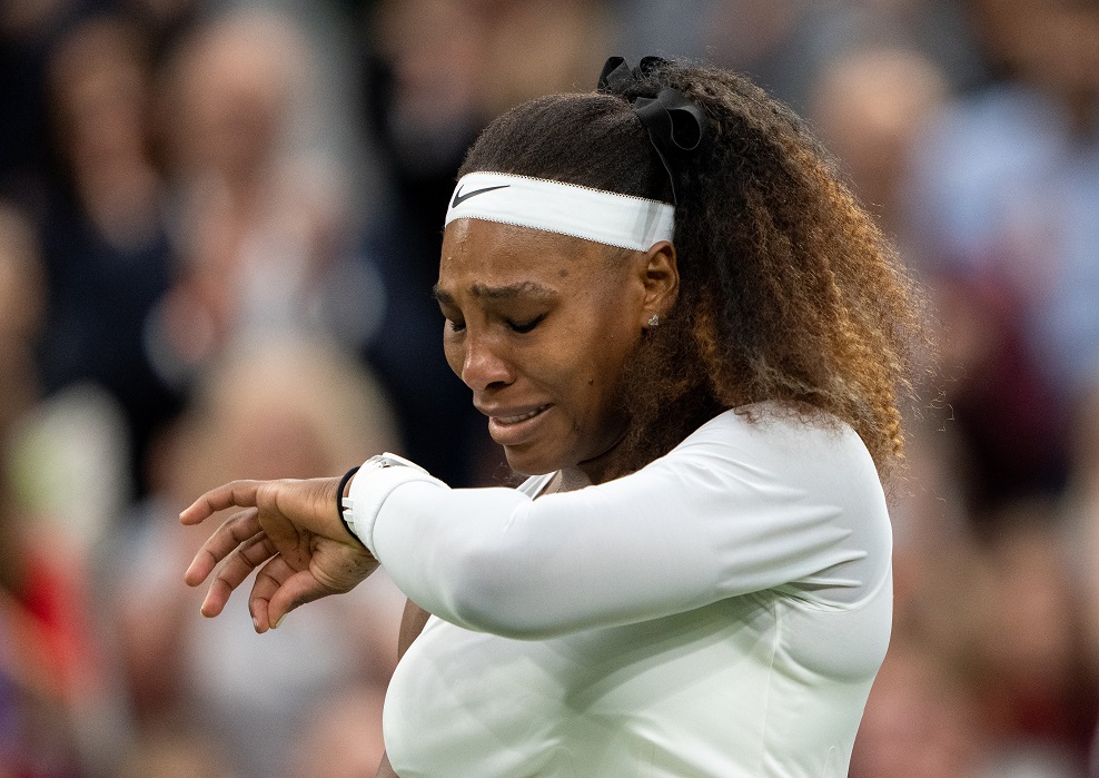 Serena Williams reacts after sustaining an injury before retiring from her first round match...