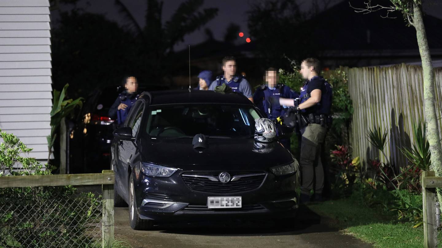 Police outside a property in Point England, Auckland, last night. Photo: NZ Herald