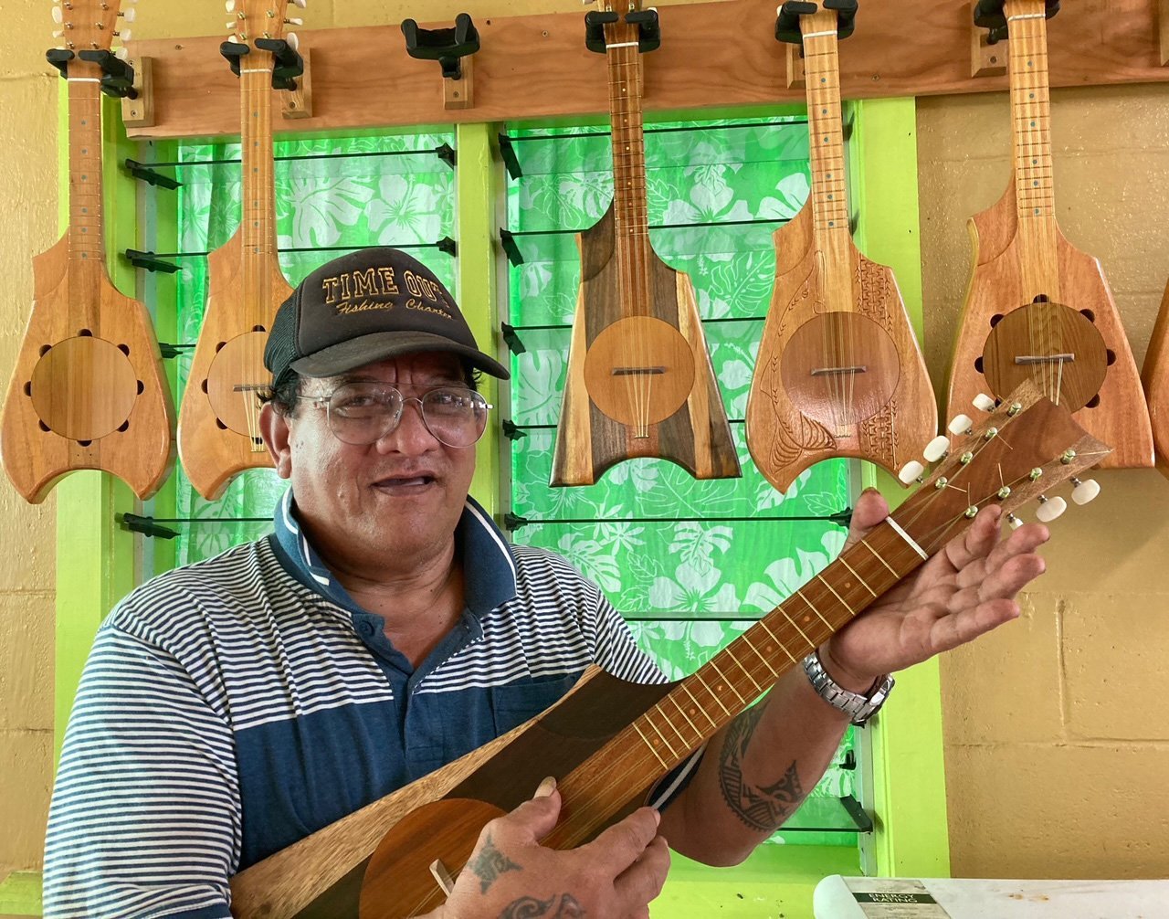 Master ukulele-maker Riki Adamu with some of his ukuleles.