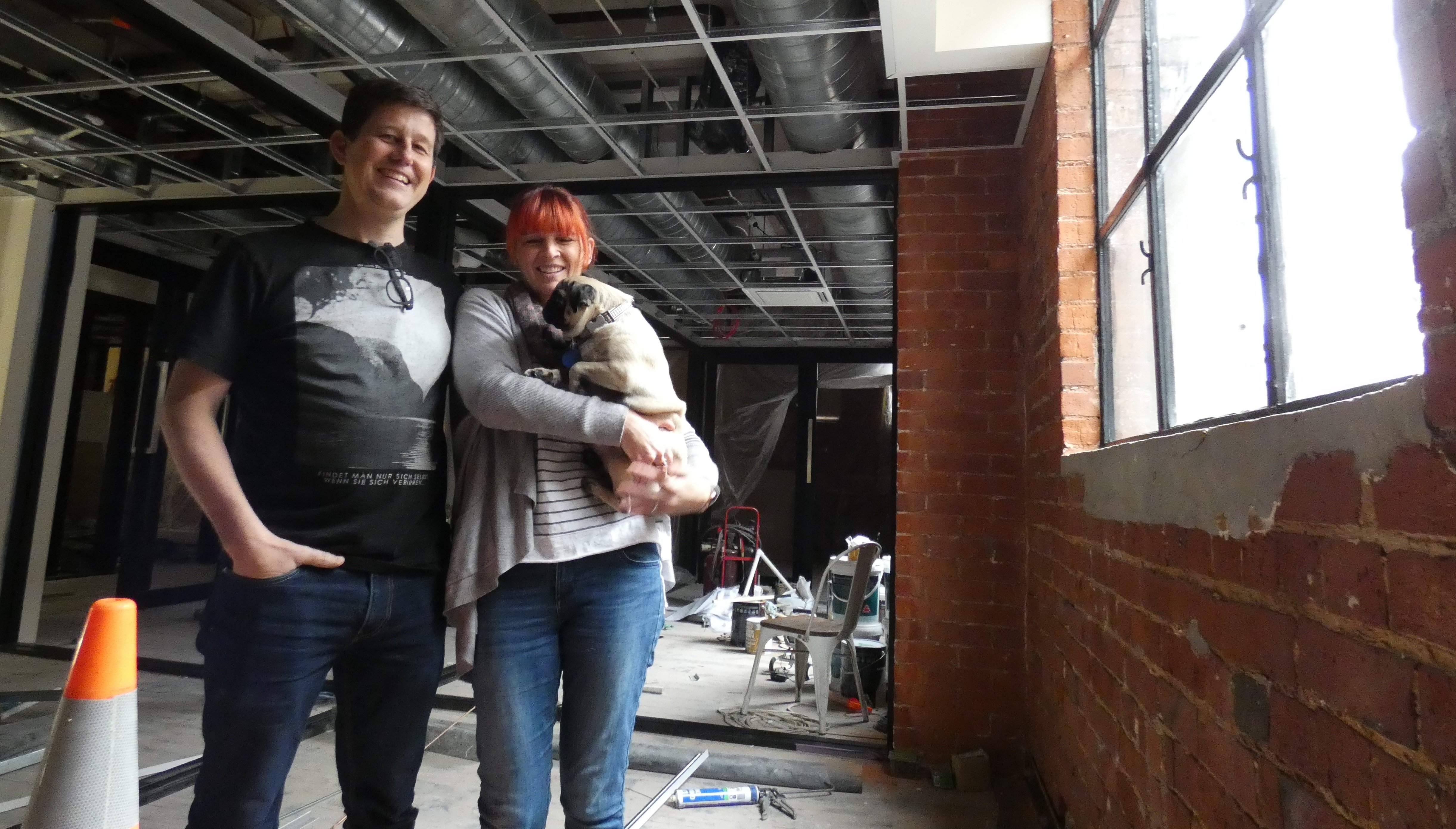 Petridish co-founders Jason and Kate Lindsey, with their pug Chai, inspect the next space being...