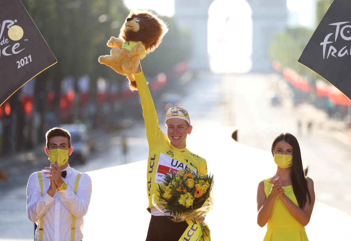 Tadej Pogacar celebrates his victory on the podium in Paris. Photo: Reuters