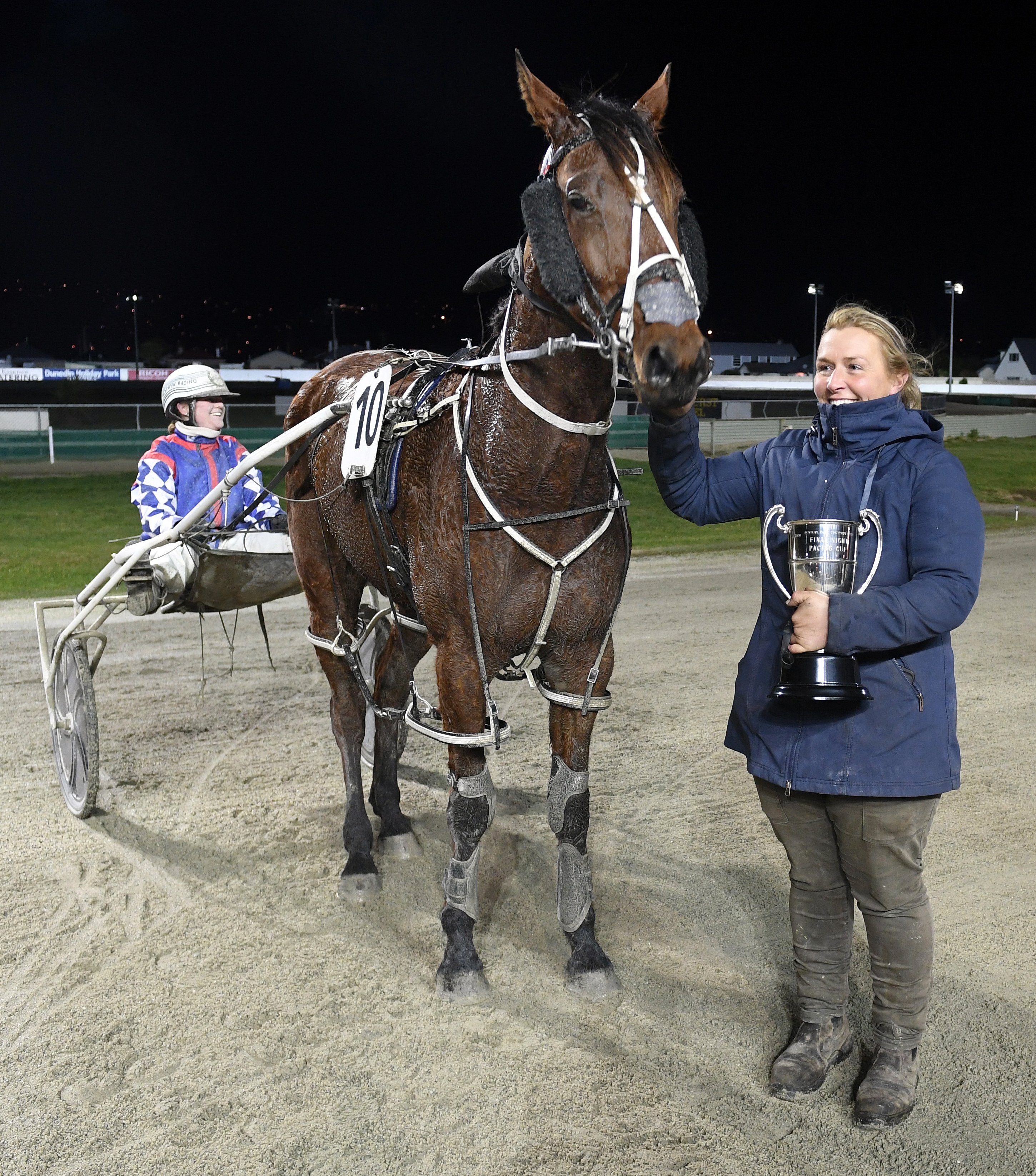 Waikouaiti trainer Amber Hoffman with driver Sarah O’Reilly and Dodgethebullet, who won the final...