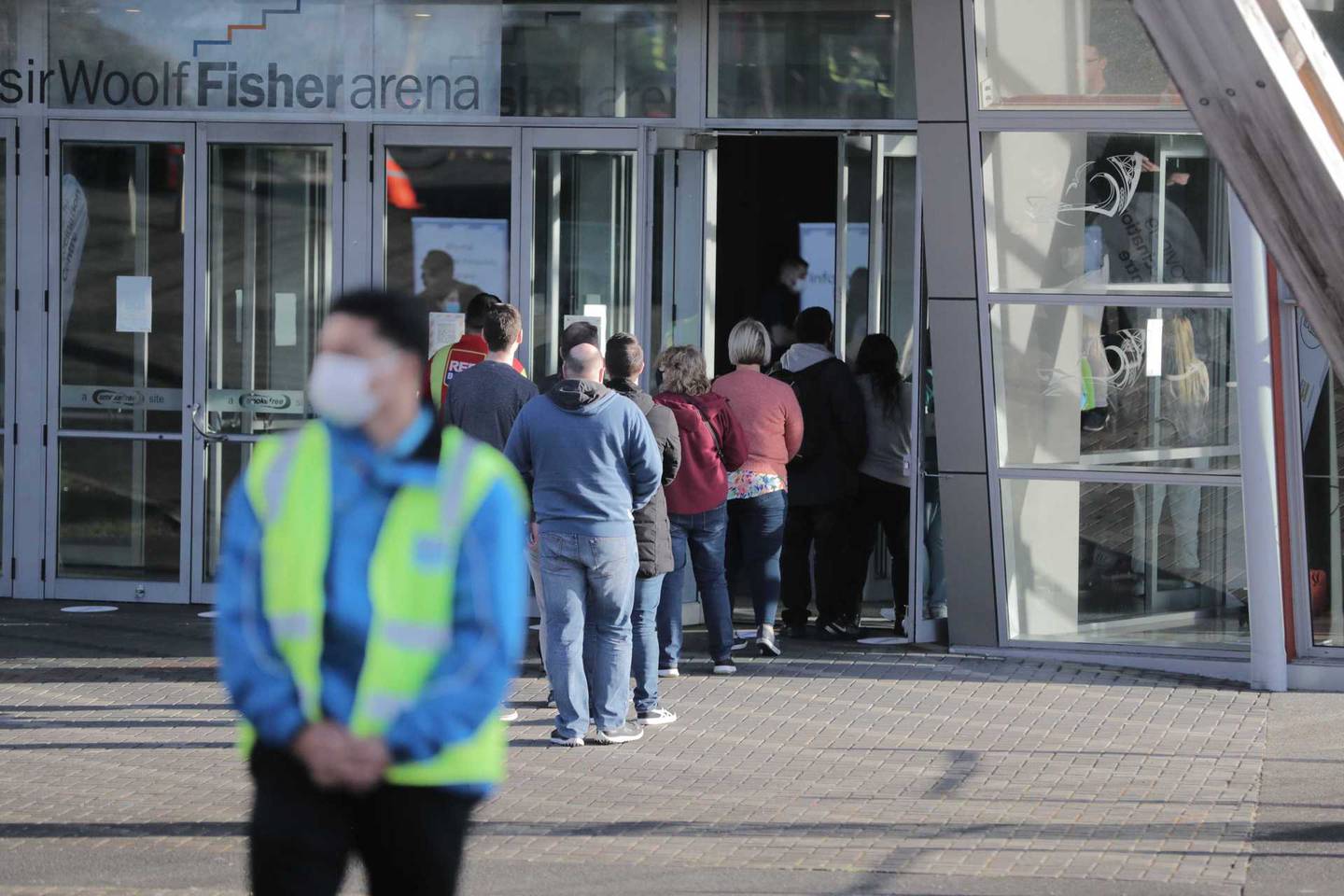 People line up for their jabs at the Manukau venue in Auckland. Photo / Michael Craig