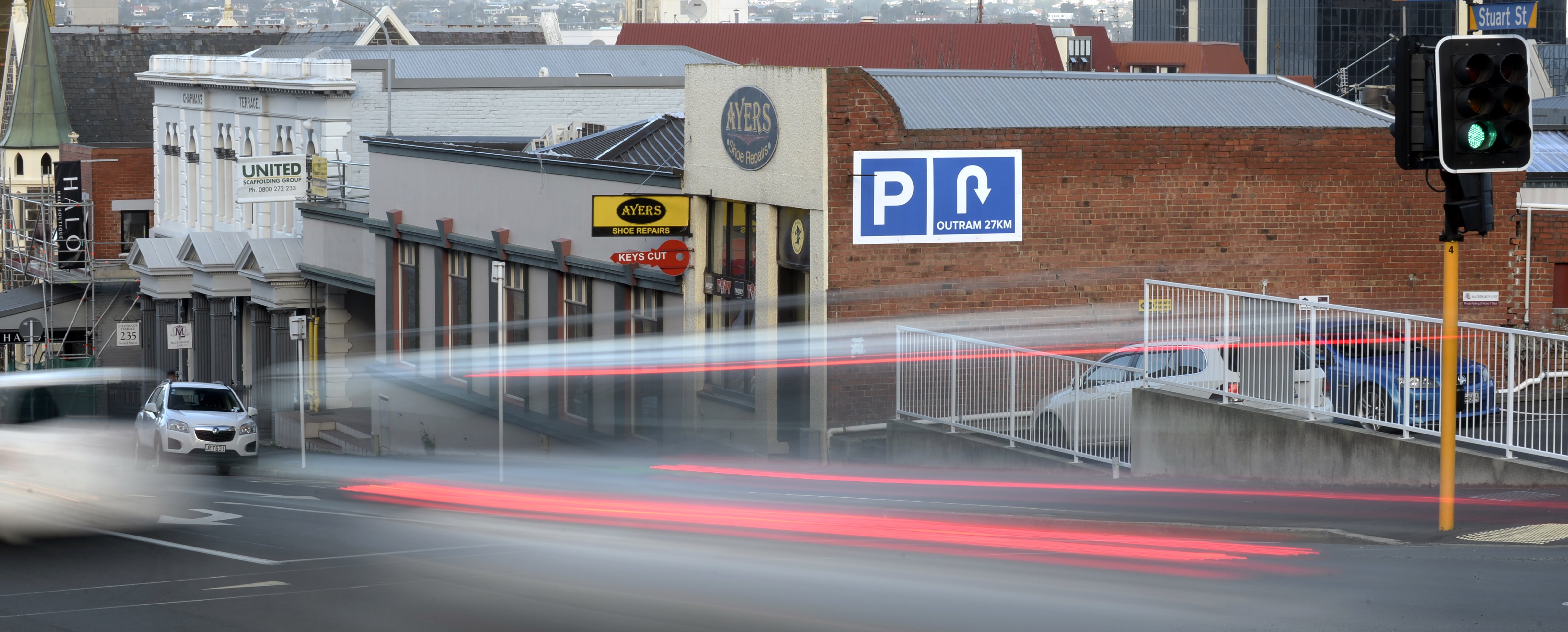 Traffic streams past a new inner city Dunedin sign which cheekily suggests that the only parking...