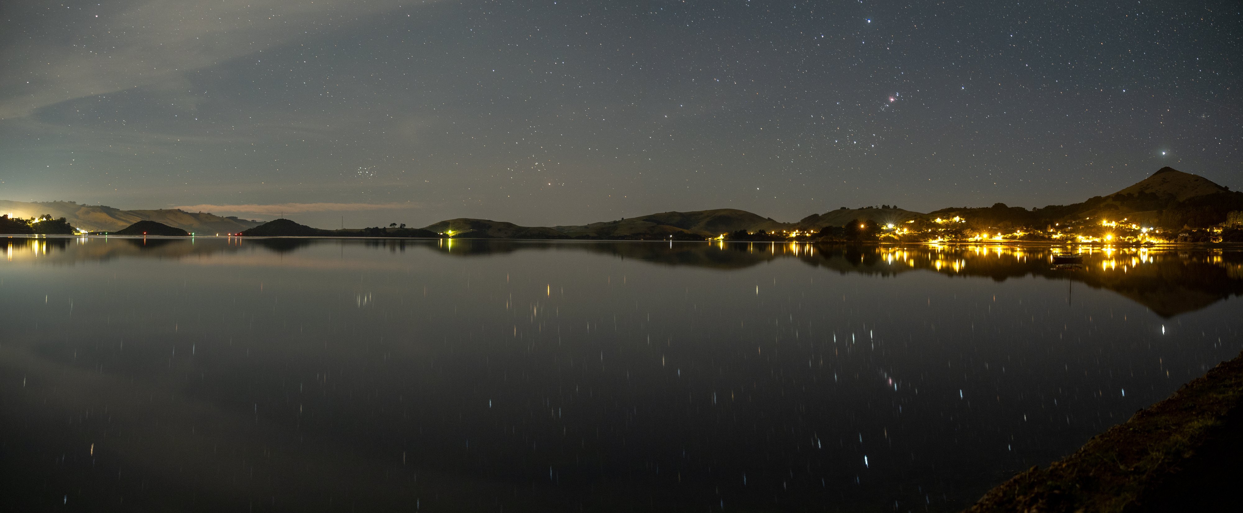 Otago Harbour’s waters became a perfect mirror recently, reflecting starlight, and streetlights....