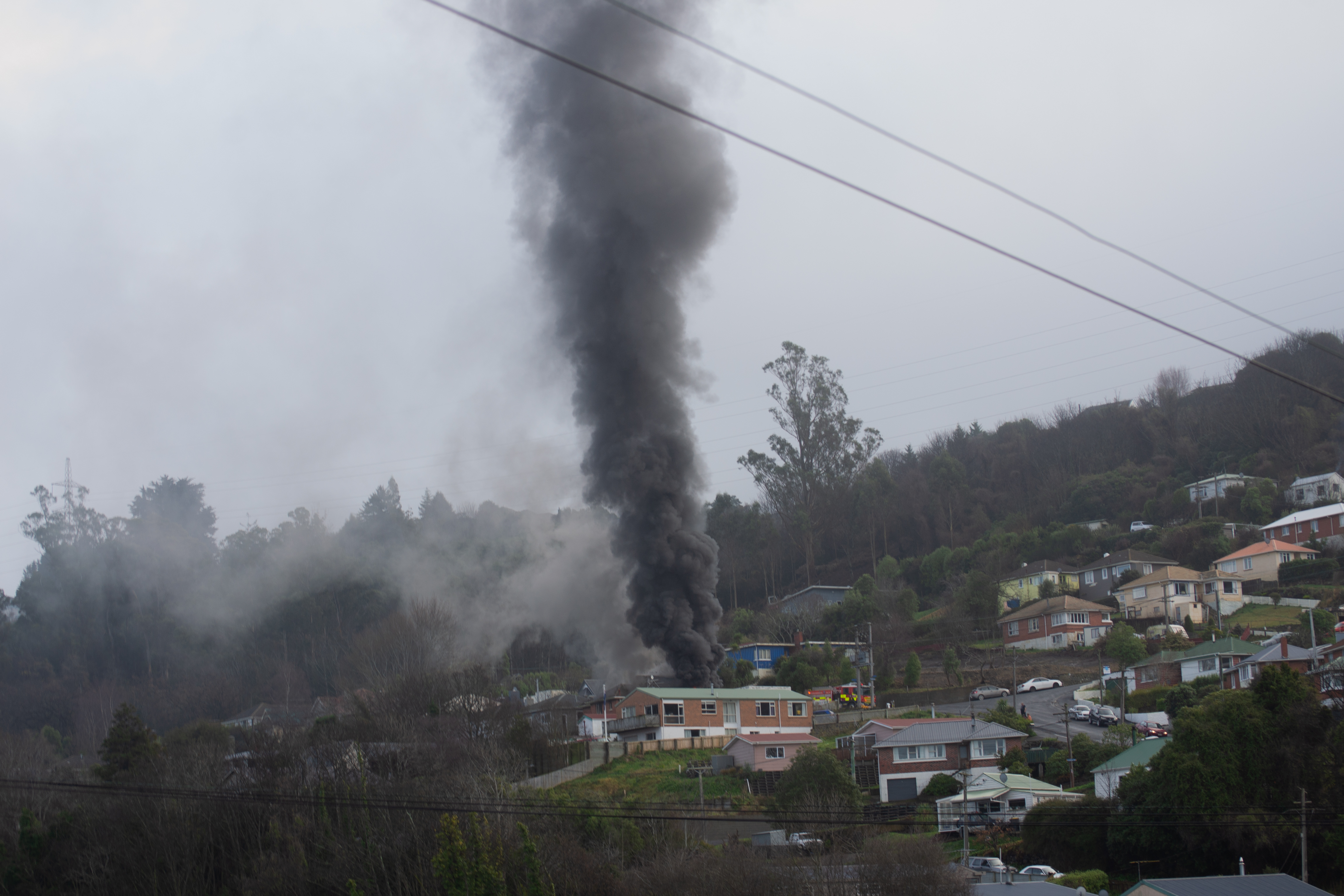 Black smoke rises from the house fire in Lookout Point. Photo: Lucas Storm