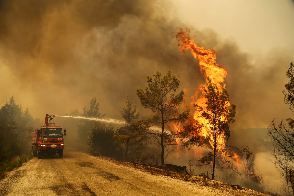 A crew battles a forest fire near the town of Manavgat, east of the resort city of Antalya. Photo...