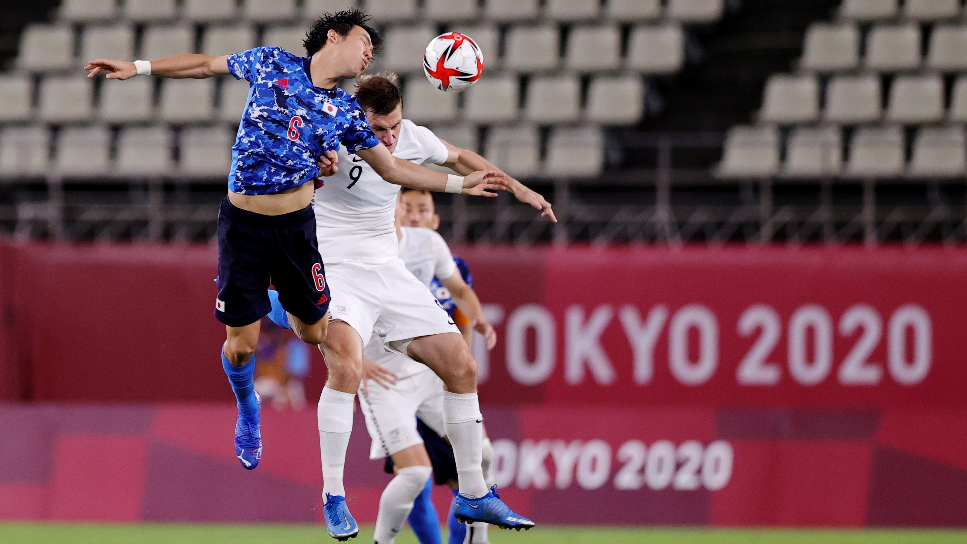 Japan's Wataru Endo and  Olywhite Chris Wood compete for the ball. Photo: Reuters 