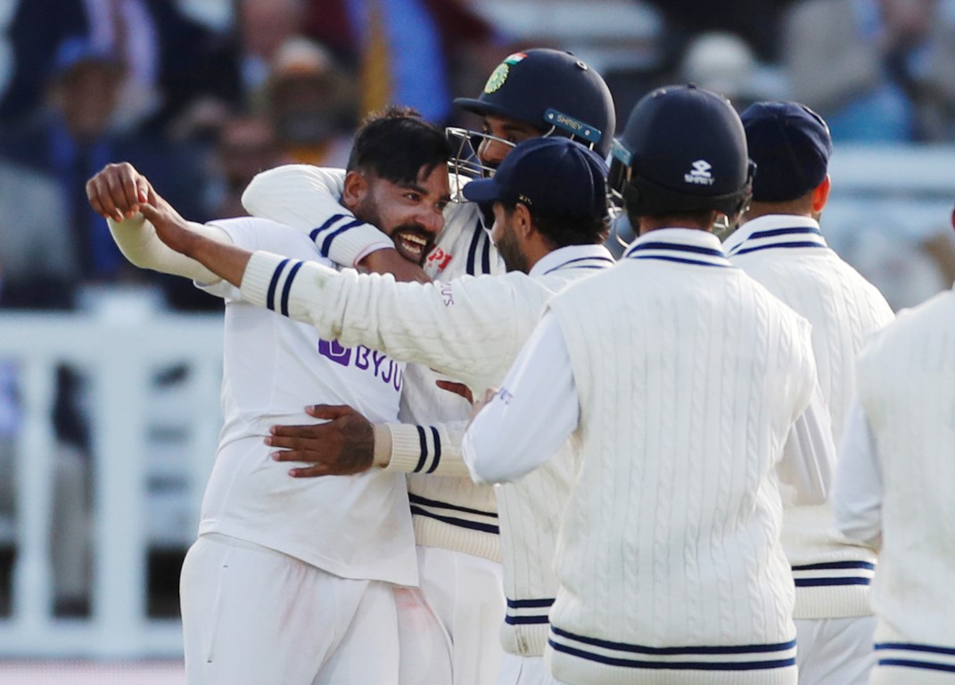 India's Mohammed Siraj celebrates with teammates after taking the wicket of England's Jos Buttler...