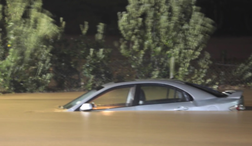 A car in floodwaters in West Auckland. Photo: NZ Herald