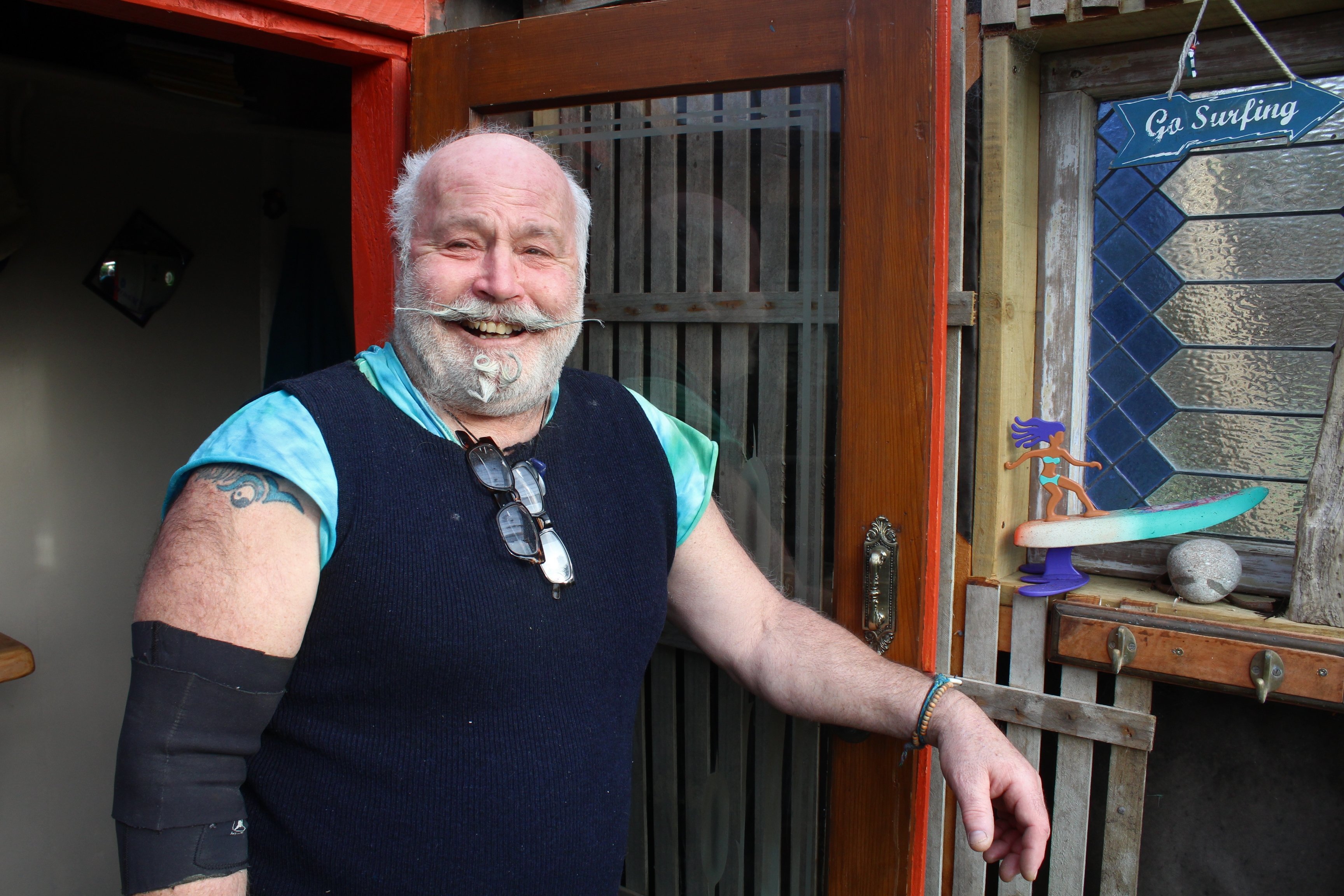 Riverton art stalwart Wayne Hill at his coastal home, which he shares with 108 surfboards. PHOTO:...