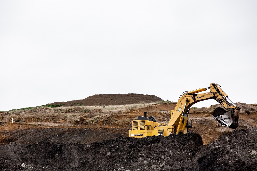 A digger excavates at Takitimu Mine, run by Bathurst Resources Ltd. The mining conglomerate hope...