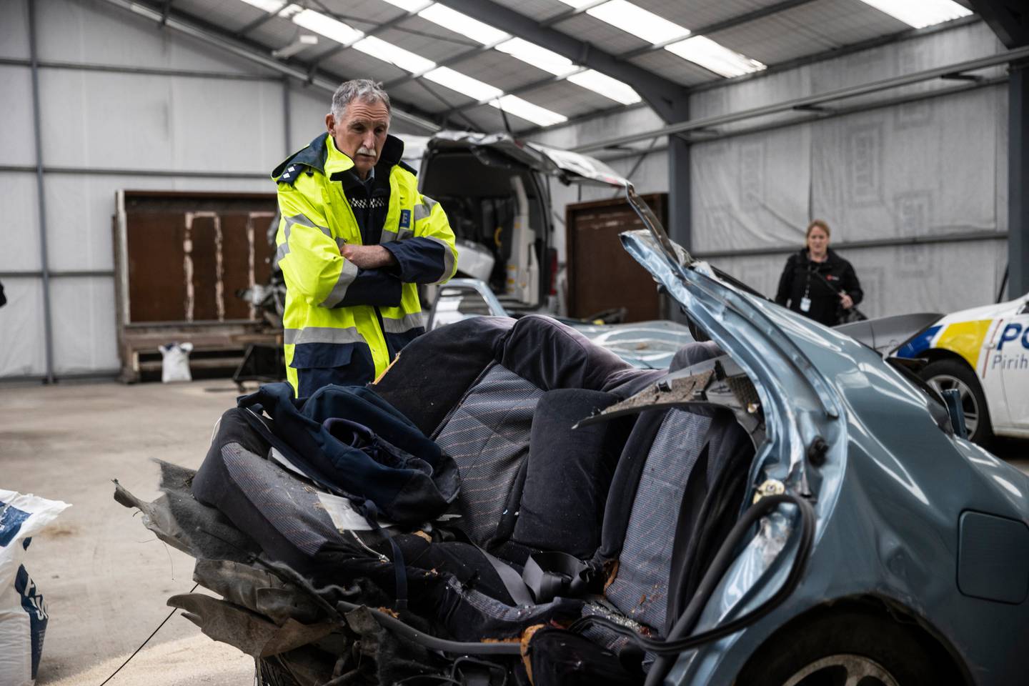 Inspector Dave Gaskin with the wreckage of the car. Photo: George Heard