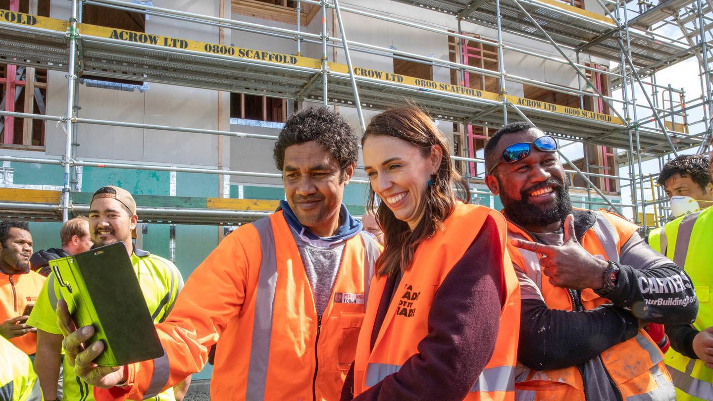 Prime Minister Jacinda Ardern posing for selfies in 2020 with tradesmen at Isles Construction in...