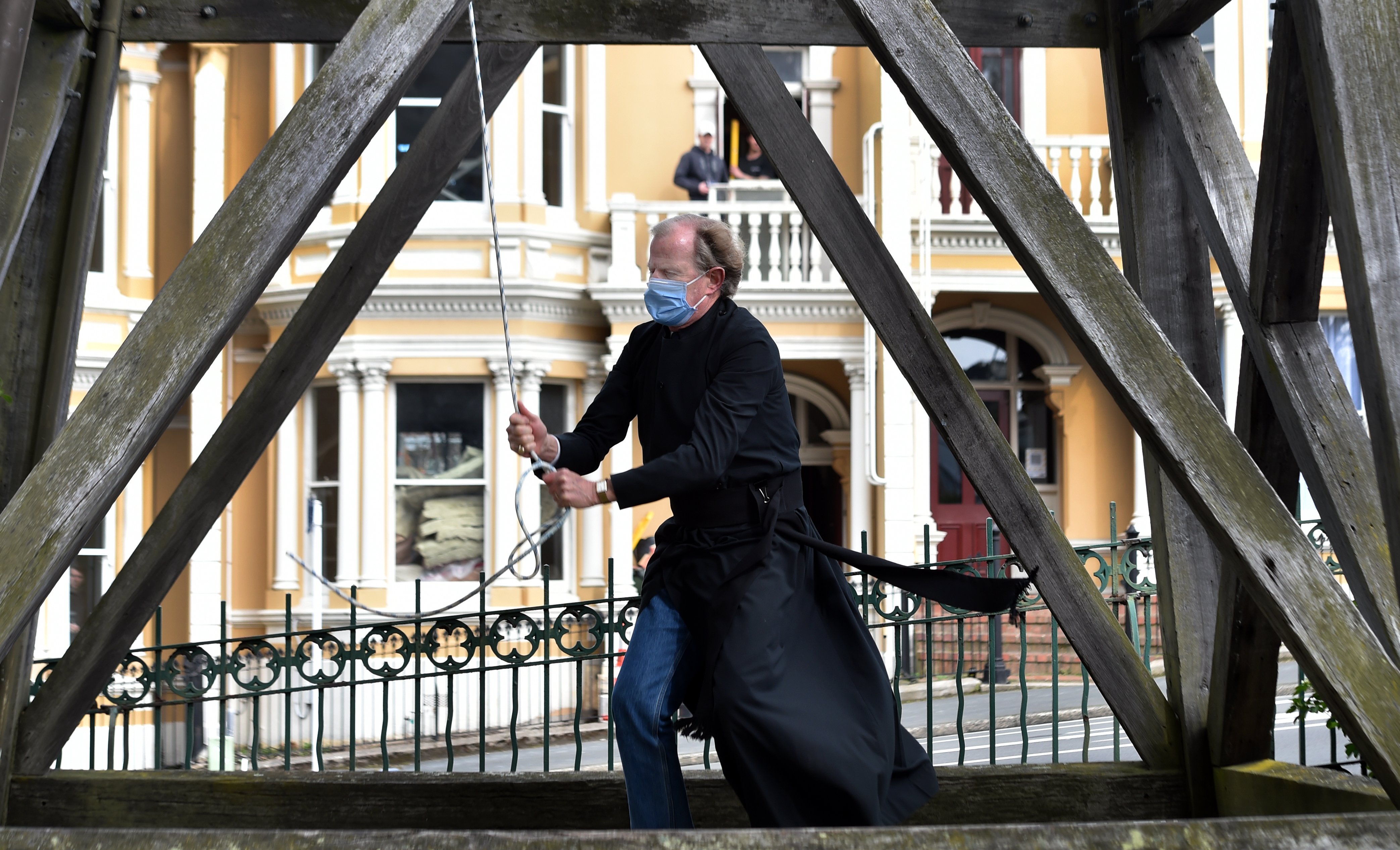  Minister Bruce Aitken rings the bell outside St Paul’s Cathedral, in Dunedin, at 1pm yesterday,...