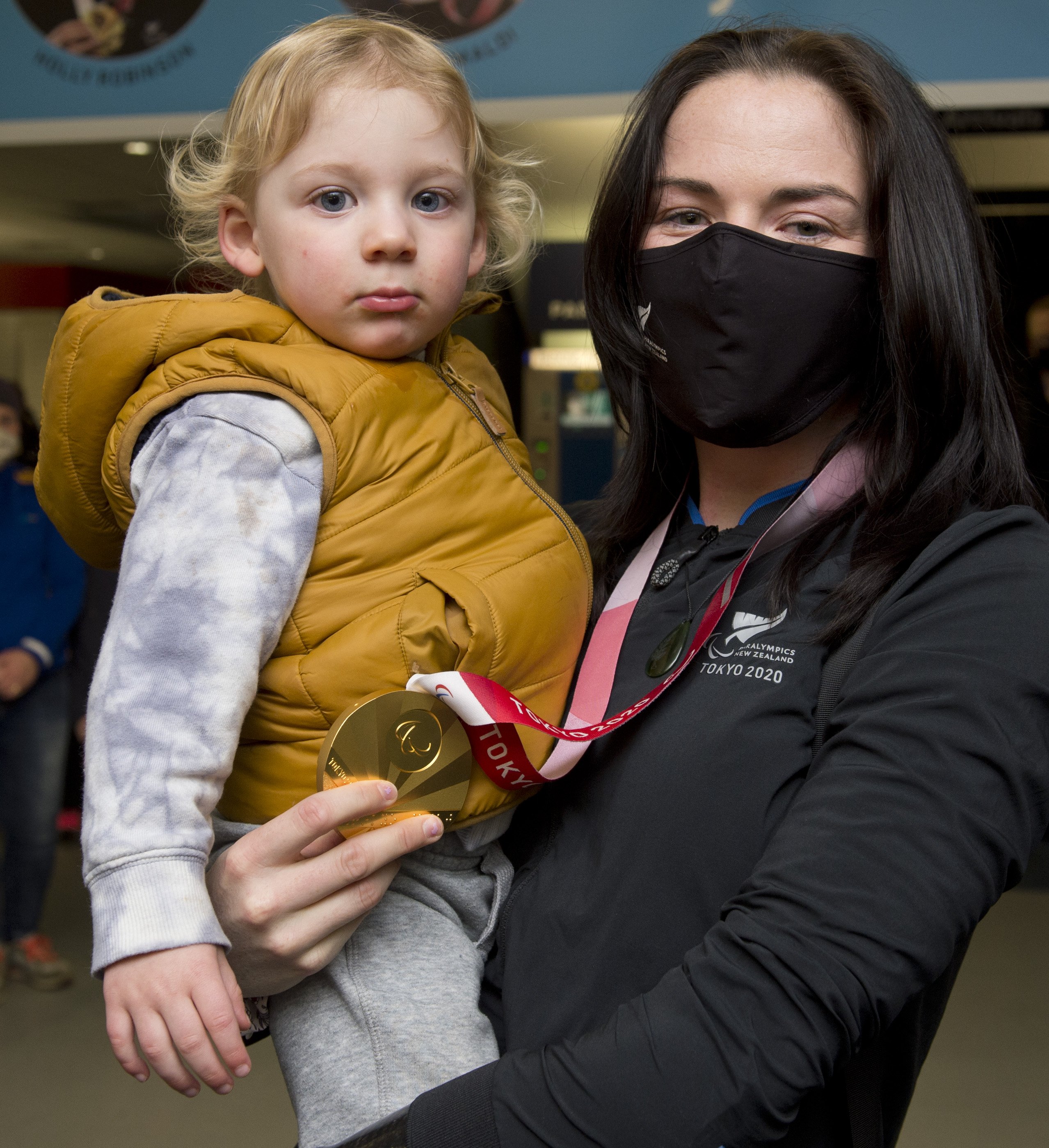 Paralympian Holly Robinson shows off her F46 javelin gold medal to godson Thomas Bates at Dunedin...