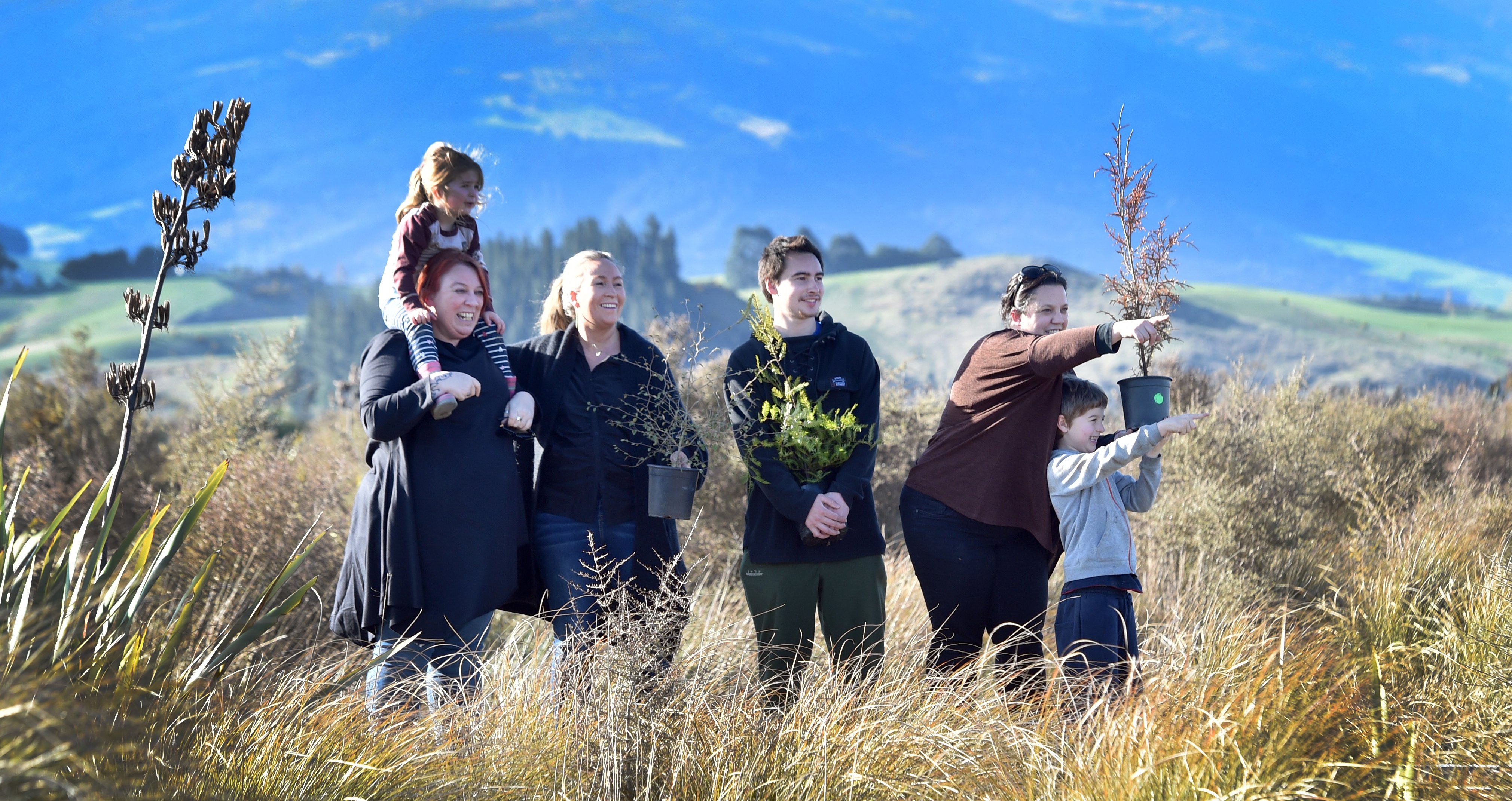 Surveying potential planting sites for native shrubs are Te Runanga o Otakou members (from left)...