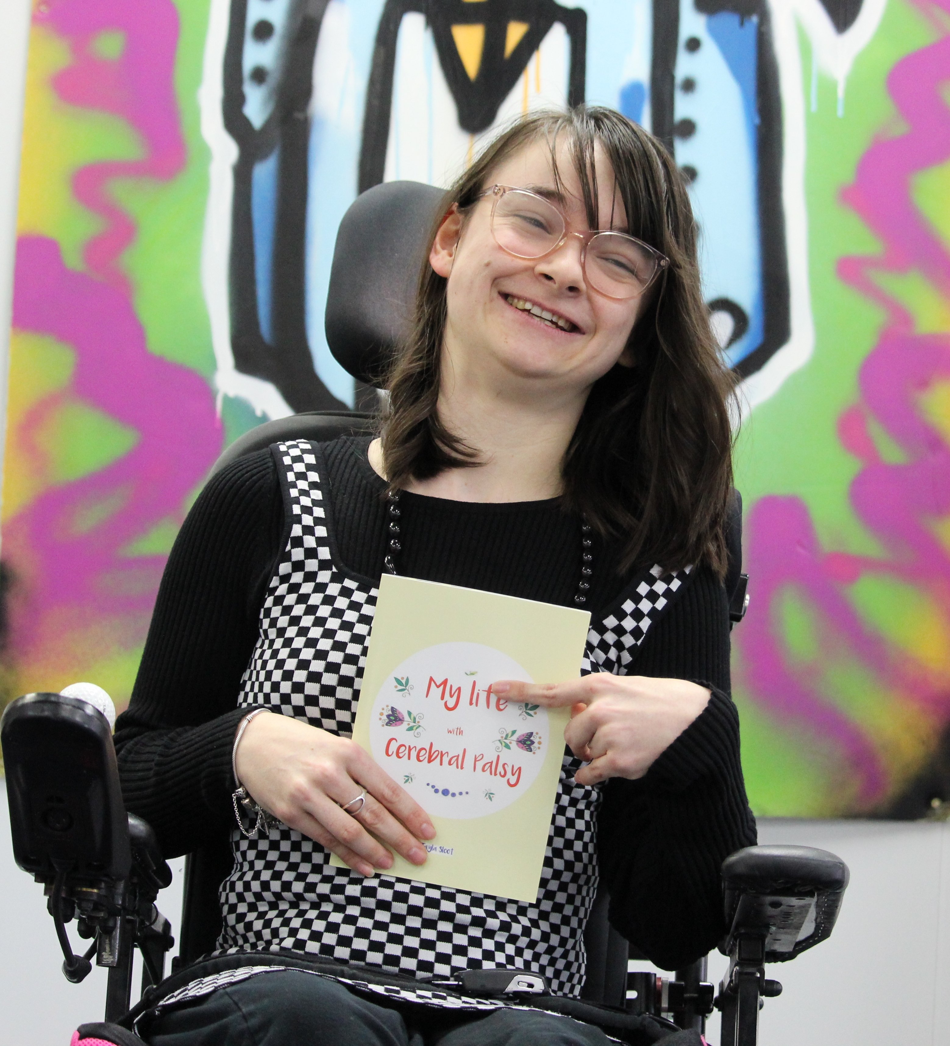 Tayla Sloot with her new book My Life with Cerebral Palsy which helps children understand her...