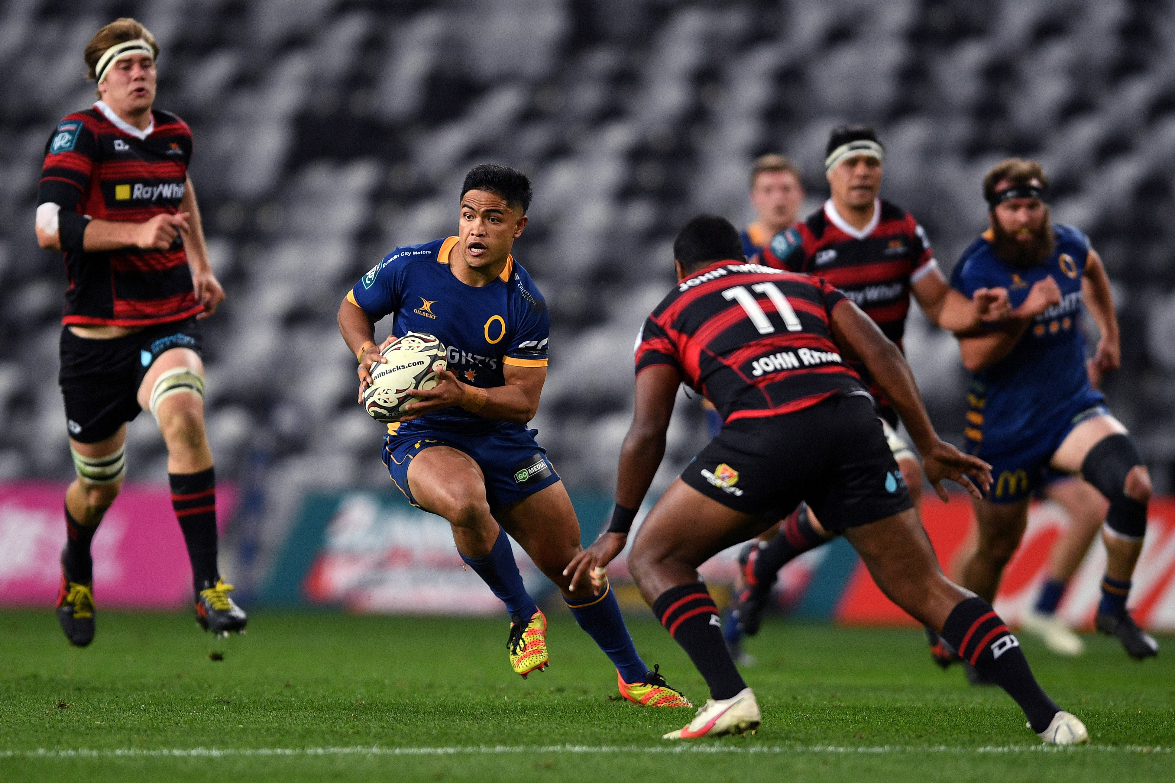 Otago first five-eighth Josh Ioane looks to sidestep Canterbury winger Manasa Mataele during the...